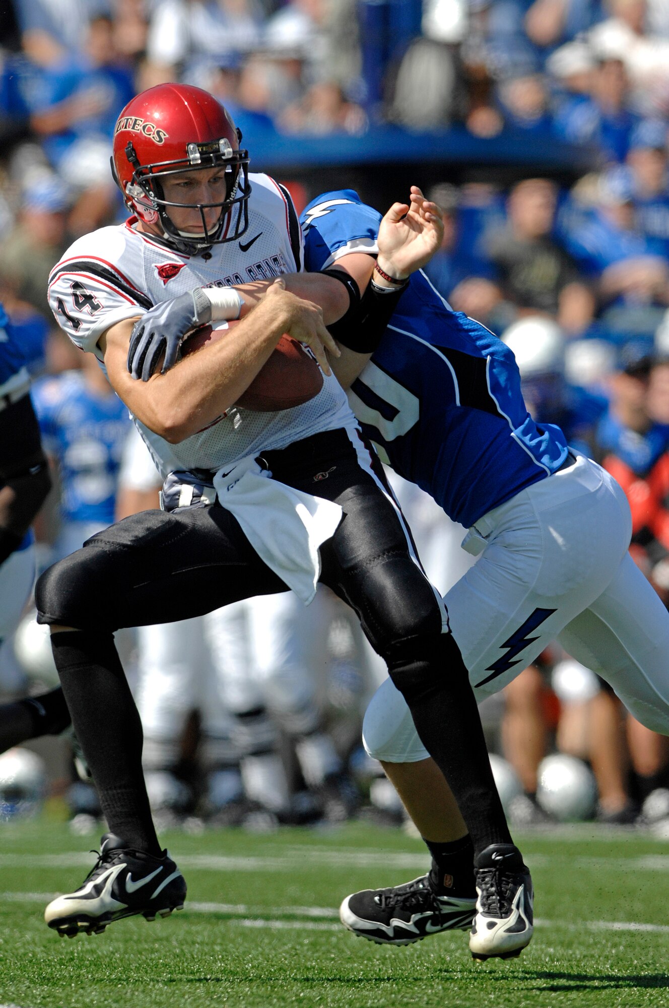 Falcons freshman outside linebacker Alex Means wraps up Aztecs quarterback Ryan Lindley for a 10-yard loss during the Falcons' 26-14 victory over San Diego State at Falcon Stadium, Colo., Sept. 26, 2009. The Falcons defense forced six turnovers from the Aztecs and scored two touchdowns. (U.S. Air Force photo/Mike Kaplan)