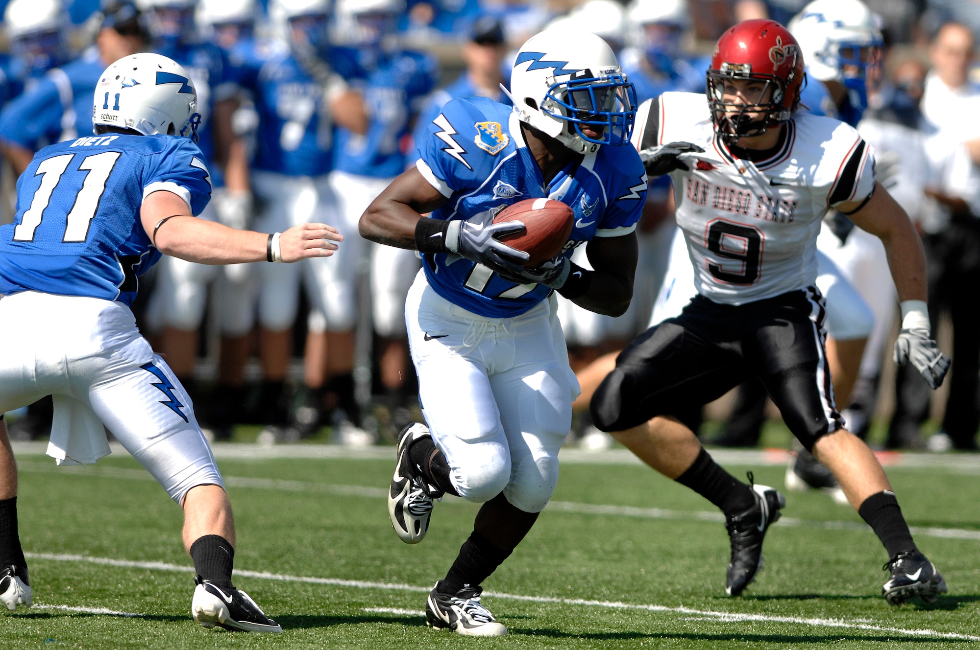 Falcons sophomore quarterback Connor Dietz hands off to sophomore running back Asher Clark on a reverse during Air Force's 26-14 win over San Diego State at Falcon Stadium, Colo., Sept. 26, 2009. Air Force ran 243 yards on 58 plays and came away with the edge on time of possession with 33:23. (U.S. Air Force photo/Mike Kaplan)