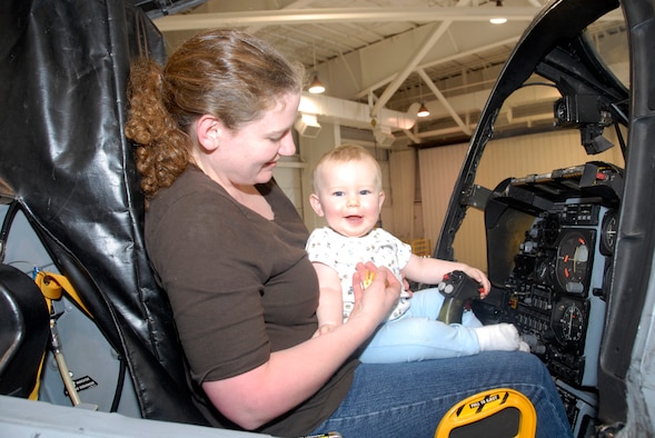 Family members of deployed reservists from the 442nd Fighter Wing's 442nd Security Forces Squadron were the guests of honor at a Yellow Ribbon Program event at Whiteman Air Force Base, Mo., Sep 26.  Here, Rose and her 1-year-old son, Scott, tour the cockpit of an A-10 Thunderbolt II in the wing's 5-Bay Hangar.  In addition to tours, the event featured forums for spouses and family members on topics such as marriage enrichment, post-traumatic stress disorder, financial management and stresses caused by multiple deployments.  The Yellow-Ribbon Program is designed to assist military members and their families deal with the rigors of reintegration following an extended combat deployment.  The 442nd SFS deploys more than any other unit in the 442nd FW, with Air Force reservists currently deployed to Kirkuk Air Base, Iraq.  The 442nd Fighter Wing is an Air Force Reserve Command unit based at Whiteman.  (U.S. Air Force photo/Maj. David Kurle) 