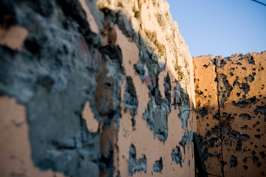 Bullet holes riddle the buildings of Range 210 after three companies of Lava Dogs assaulted through the town to clear out simulated enemy forces.