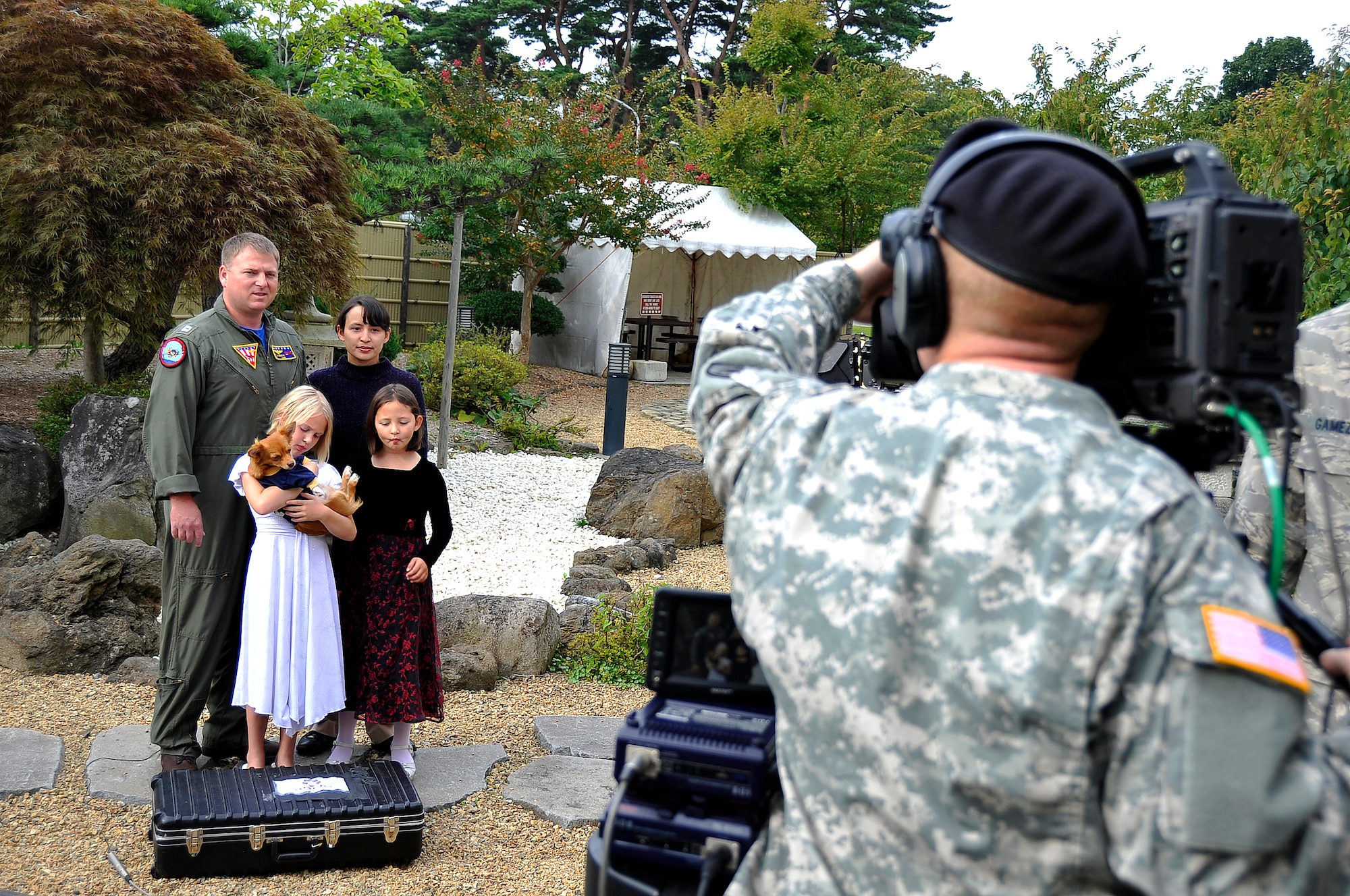 MISAWA AIR BASE, Japan – Lt. Theodore Kubisiak, Naval Air Facility, and his family record a holiday greeting video Sept. 28, which will be aired to their family back in Texas. The hometown news team will be recording greetings at the officer’s club ballroom garden today and tomorrow from 9 a.m. to 5 p.m. (U.S. Air Force photo/Staff Sgt. Chad C. Strohmeyer).