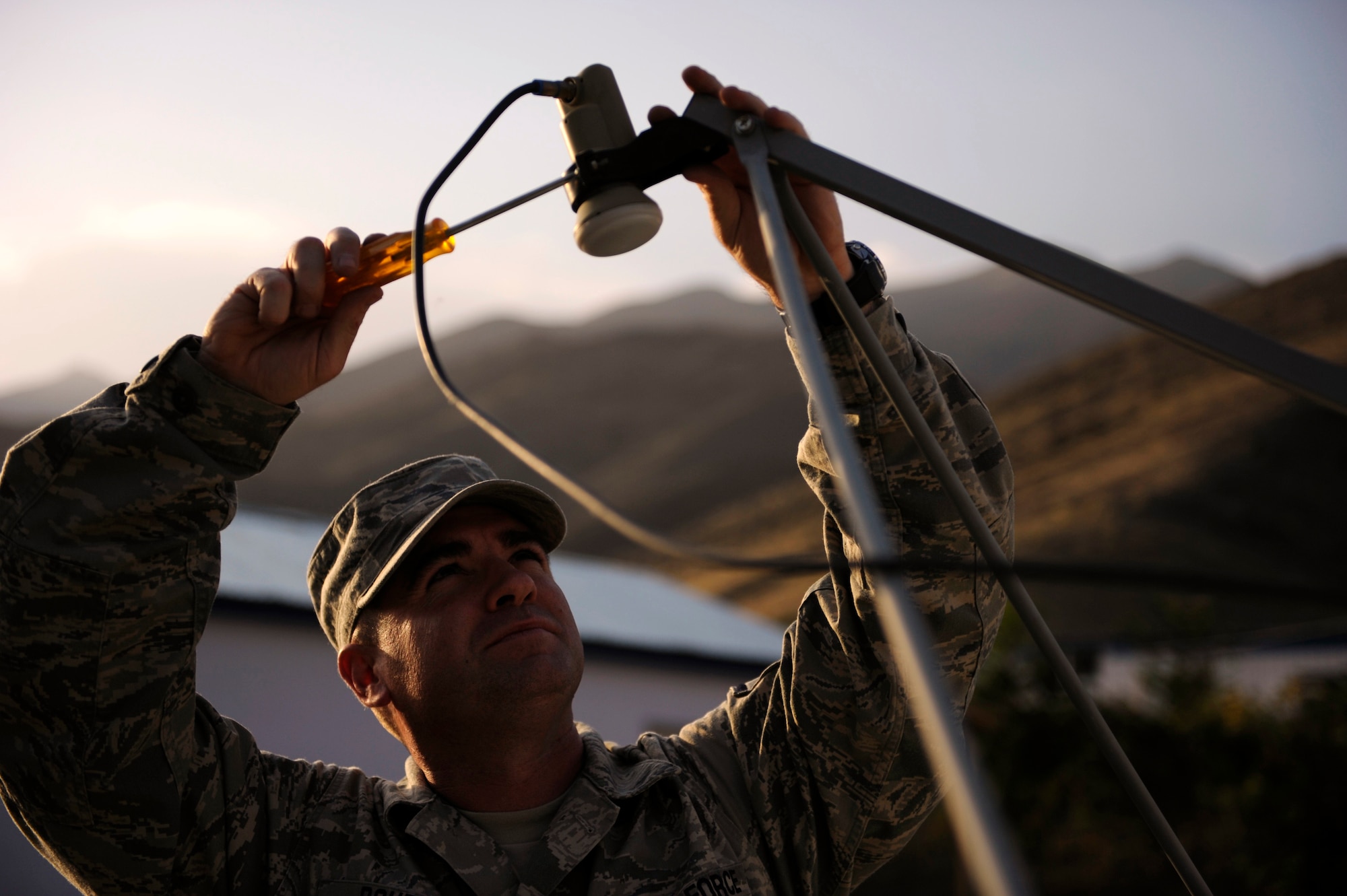 PANJSHIR, Afghanistan - Master Sgt. Ira Doubet adjusts the Armed Forces Network antenna in preparation for the start of a football game Sept. 11, 2009. Sergeant Doubet is the noncommissioned officer-in-charge of the command post at the provincial reconstruction team here. He's a Cambridge Springs, Penn., native deployed from Schriever Air Force Base, Colo. (U.S. Air Force photo/Staff Sgt. J.G. Buzanowski)