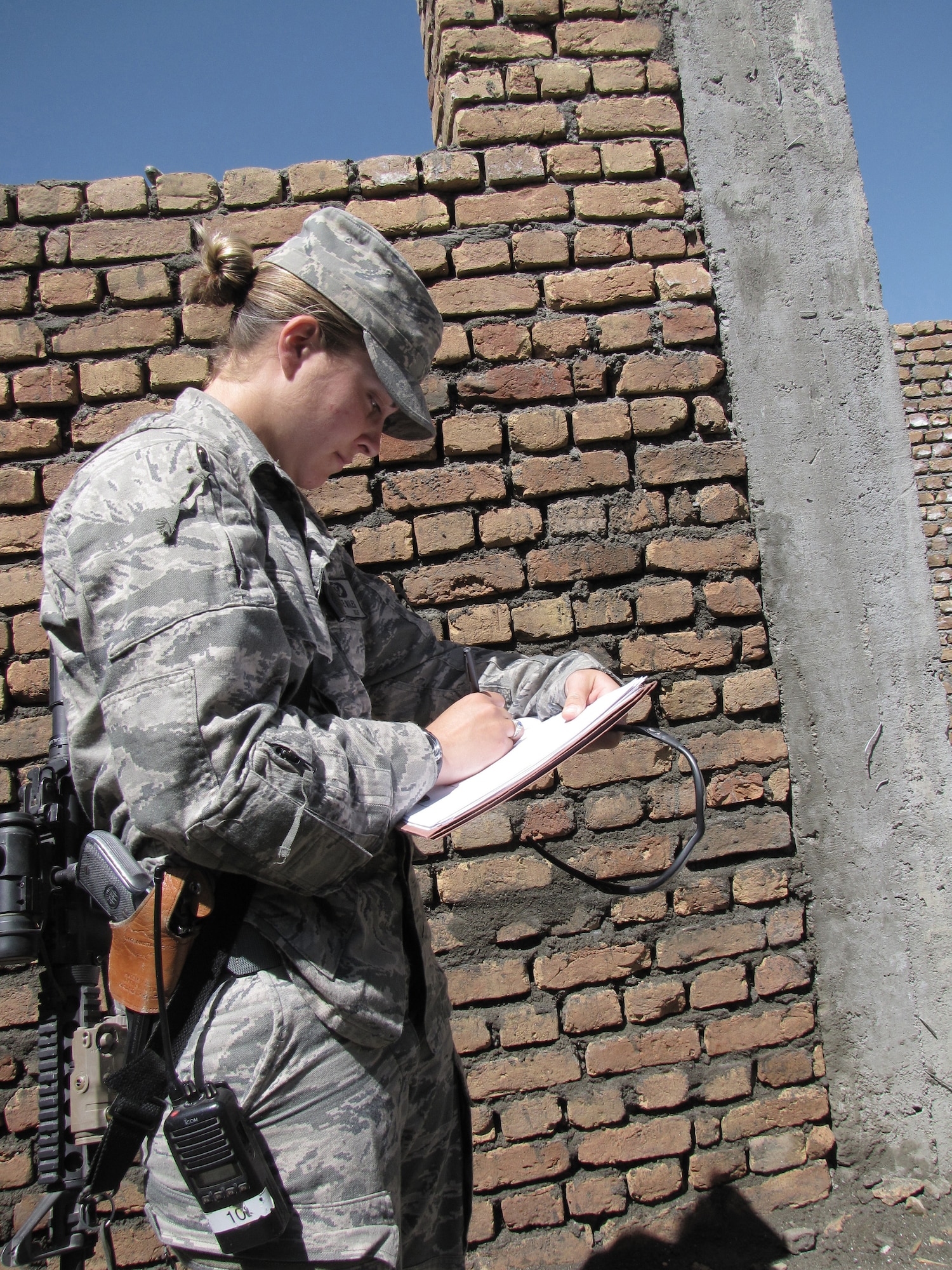 PANJSHIR, Afghanistan - A civil engineer with the provincial reconstruction team here, 1st Lt. Kate Miles takes notes on construction progress of a new government building Sept. 6, 2009. Lieutenant Miles and her team ensure contractors perform work according to code. She is a Rochester, N.Y., native and deployed from Luke Air Force Base, Ariz. (U.S. Air Force photo/Staff Sgt. J.G. Buzanowski)