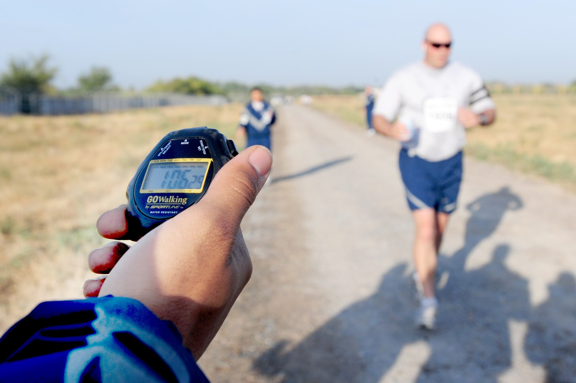 TRANSIT CENTER AT MANAS, Kyrgyzstan -- Maj. Grant Vineyard, 376th Expeditionary Force Support Squadron commander, completes the first leg of the race for his team as part of the Manas Marathon, Sept. 19, 2009. (U.S. Air Force photo/Senior Airman Steele C. G. Britton)