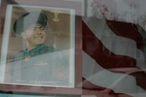 A storefront displays a picture of Sgt. John Basilone along with an American Flag in Raritan, N.J., Sept 27. This small, 7,000-person town host the largest military parades and one of the only in tribute to an enlisted Marine. Basilone received the Medal of Honor for his actions keeping multiple heavy machine guns firing to repel an overwhelming Japanese assault at Guadalcanal. (Marine Corps photo by Sgt. Randall A. Clinton)