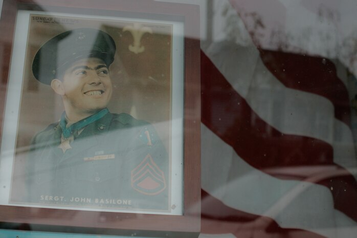 A storefront displays a picture of Sgt. John Basilone along with an American Flag in Raritan, N.J., Sept 27. This small, 7,000-person town host the largest military parades and one of the only in tribute to an enlisted Marine. Basilone received the Medal of Honor for his actions keeping multiple heavy machine guns firing to repel an overwhelming Japanese assault at Guadalcanal. (Marine Corps photo by Sgt. Randall A. Clinton)