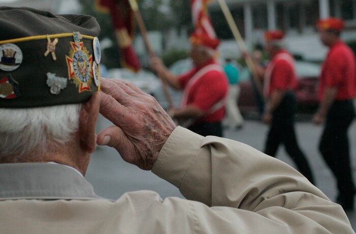 Joeseph Kovac, a retired sailor and Veterans of Foreign Wars past commander, salutes one of many color guards in the John Basilone Parade in Raritan, N.J., Sept. 27. The parade is the largest military parade in the nation and honors Basilone, a native Marine hero. (Marine Corps photo by Sgt. Randall A. Clinton)