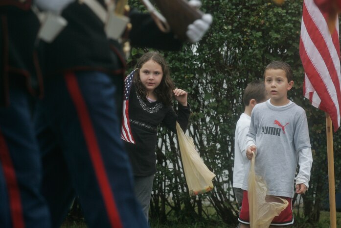 Two children stare as a Marine Corps color guard passes by on the John Basilone Parade route in Raritan, N.J., Sept. 27. The parade is the largest military parade in the nation and honors Basilone, a native of the town, who received a Medal of Honor and Navy Cross for actions in Guadalcanal and Iwo Jima. (Marine Corps photo by Sgt. Randall A. Clinton)
