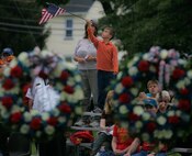 A child waves a flag during the wreath laying ceremony at the John Basilone Statue in Raritan, N.J., Sept. 27. The celebration of the town's Medal of Honor recipient is the largest in the nation. (Marine Corps photo by Sgt. Randall A. Clinton)