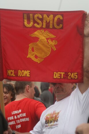 A supporter from the Marine Corps League chapter in Rome, N.Y., cheers on wounded warriors participating in the 8th Annual Tunnel-To-Towers Run in New York City Sept. 27, 2009.  The run commemorates Firefighter Stephen Siller, New York City Fire Department, who ran 3.1 miles through the tunnel connecting Brooklyn and Manhattan Sept. 11, 2001, carrying 70 lbs. of gear to assist at the World Trade Center before dying in the towers' collapse.  Despite a steady rain, approximately 25,000 runners took part in the event.