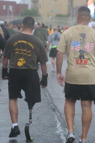 Former Marine Corps Sgt. Eric Morantes walks with another wounded warrior to the start of the 8th Annual Tunnel-To-Towers Run in New York City Sept. 27, 2009.  The run commemorates Firefighter Stephen Siller, New York City Fire Department, who ran 3.1 miles through the tunnel connecting Brooklyn and Manhattan Sept. 11, 2001, carrying 70 lbs. of gear to assist at the World Trade Center before dying in the towers' collapse.  Despite a steady rain, approximately 25,000 runners took part in the event.