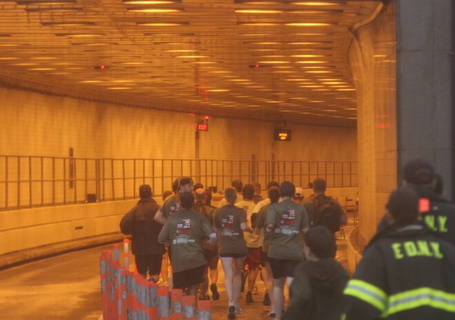 Volunteers accompanying wounded warriors enter the Brooklyn Battery Tunnel connecting Brooklyn with lower Manhattan during the 8th Annual Tunnel-To-Towers Run in New York City Sept. 27, 2009.  The run commemorates New York City Firefighter Stephen Siller, who ran 3.1 miles through the tunnel connecting Brooklyn and Manhattan Sept. 11, 2001, carrying 70 lbs. of gear to assist at the World Trade Center before dying in the towers' collapse.  Despite a steady rain, approximately 25,000 runners took part in the event.