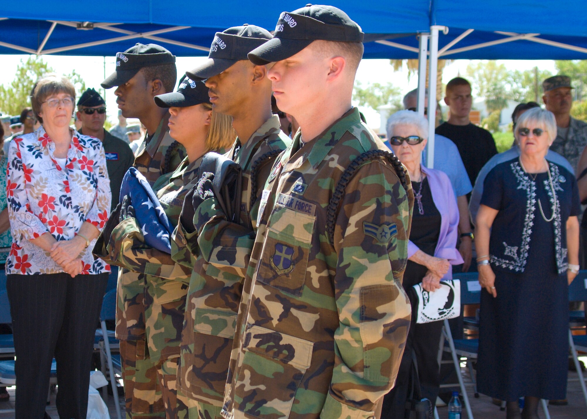 Members of Edwards Blue Eagles Honor Guard stand in front of the families of servicemembers listed as missing in action, former prisoners of war, their families and members of Team Edwards during a retreat ceremony in front of the Air Force Flight Test Center Headquarters Sept. 18. The retreat ceremony concluded Team Edwards two-day observance of POW/MIA Day. (Air Force photo Mike Cassidy)