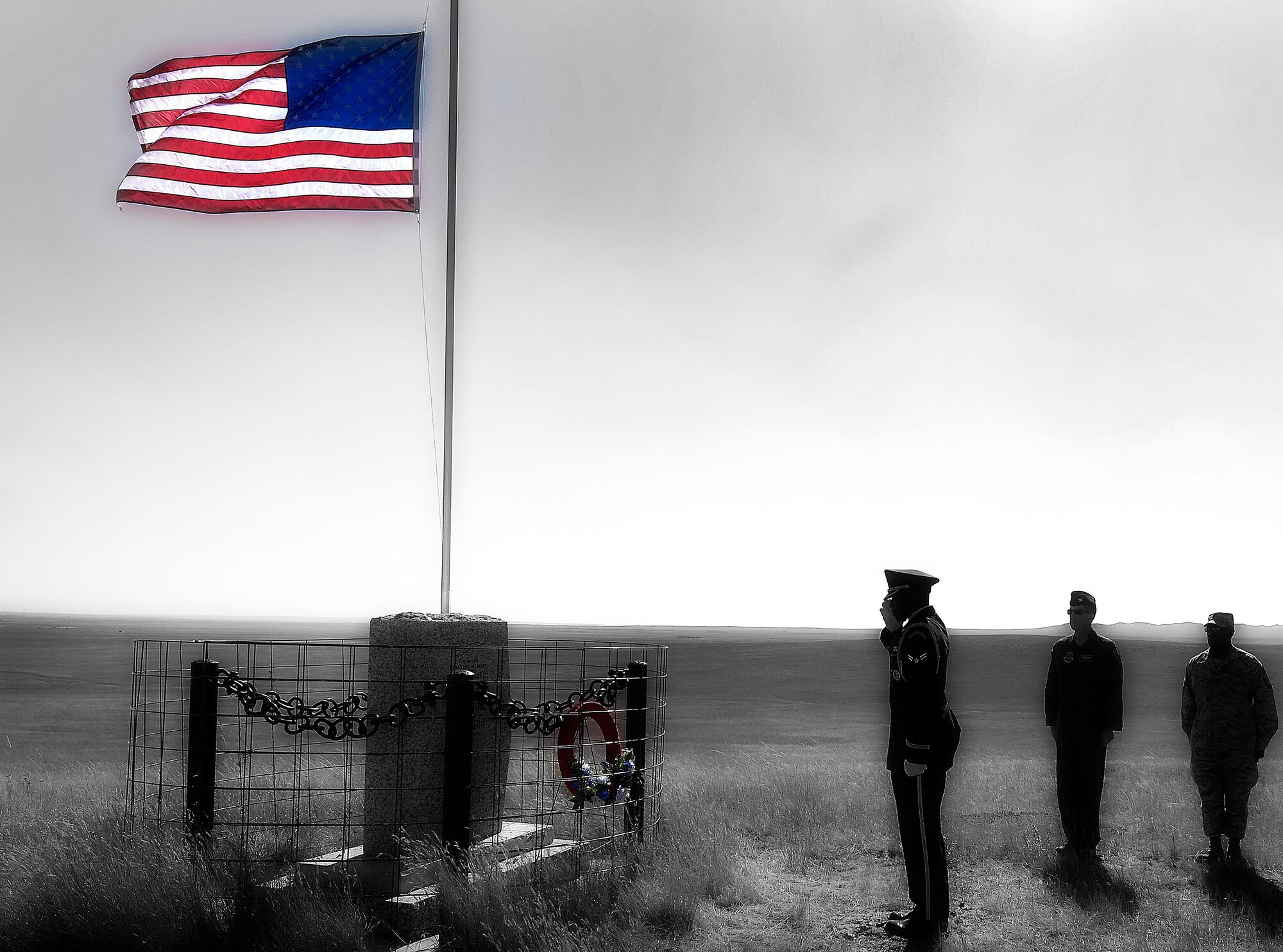 Airman 1st Class Brandon Bussey, 28th Logistics Readiness Squadron traffic management journeyman, salutes the Fury-2 Memorial near Ekalaka, Mont., Sept. 26. The memorial is in remembrance of four Airmen who lost their lives when a B-1 crashed 12 years ago. (U.S. Air Force photo illustration/Airman 1st Class Joshua J. Seybert)