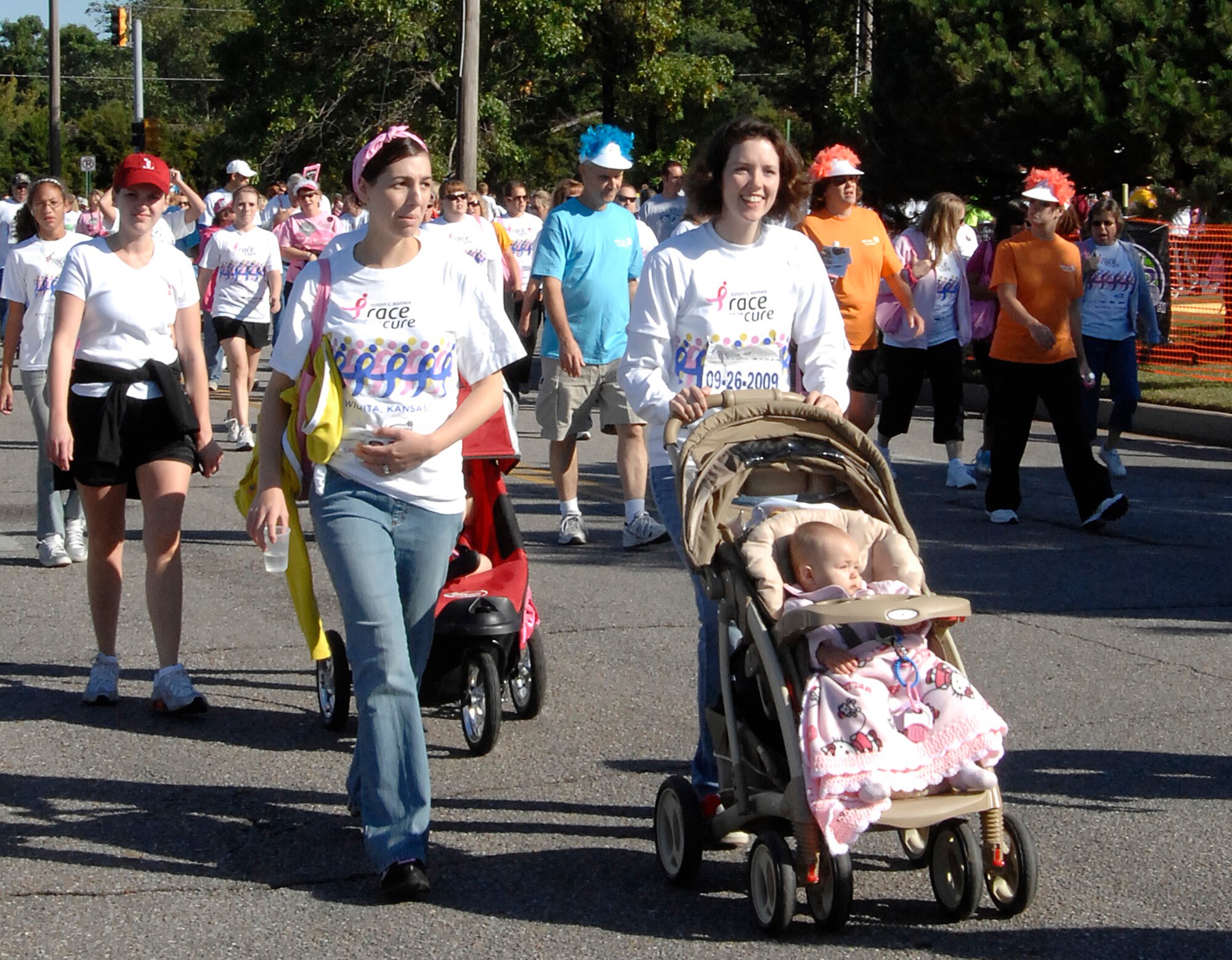 Team McConnell members, Senior Airman Felicia Butler, and Staff Sgt. Jamie Train and her one-year-old daughter, Kylie, participate in the 3.2-mile, 2009 Susan Komen Race for the Cure, Sept. 26, 2009,in Wichita, Kan. This year marked the race’s 25th anniversary. The event raises money for breast cancer awareness. (U.S. Air Force photo/Senior Airman Laura Suttles)