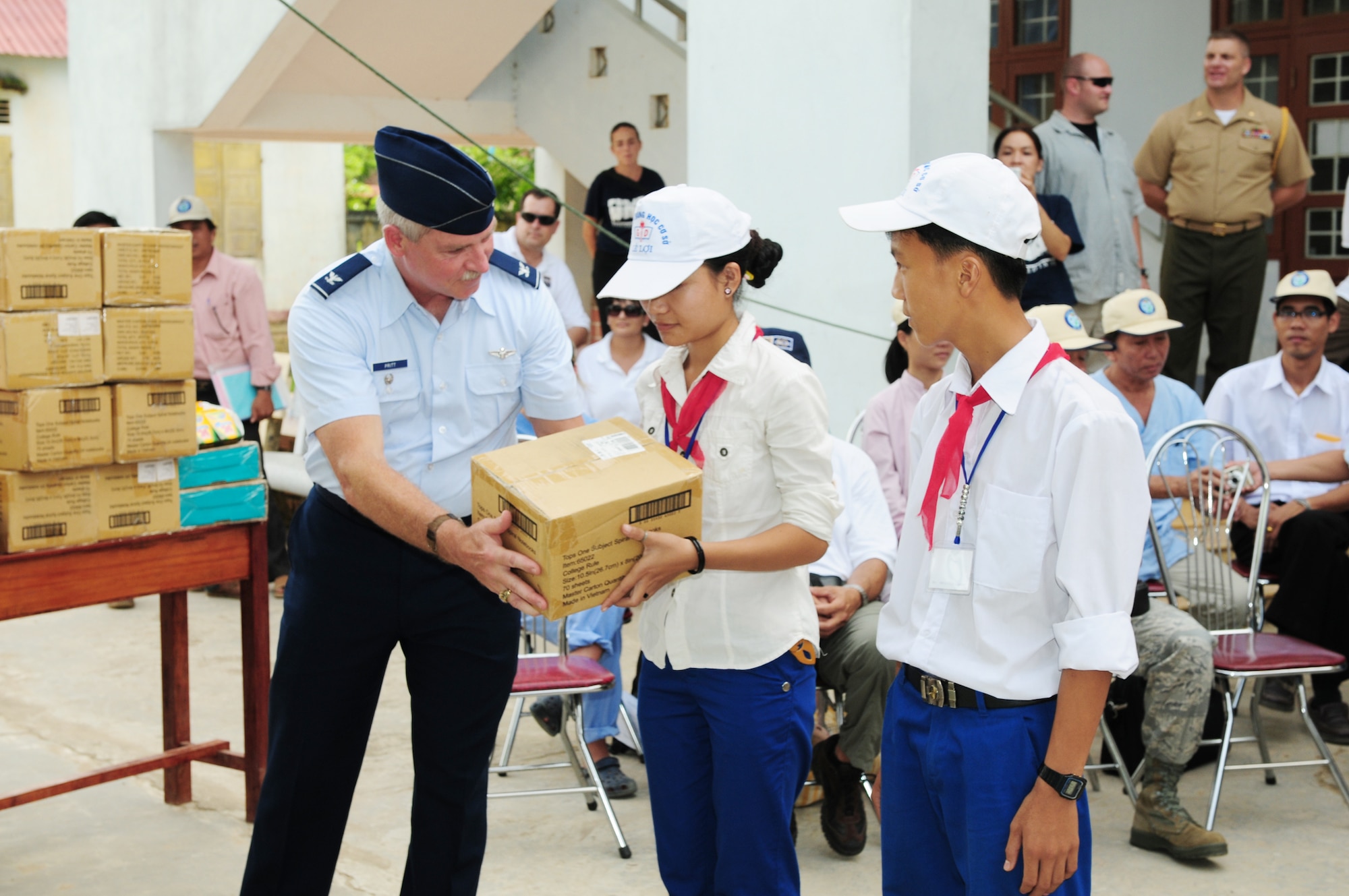 Col. Wayne Pritt presents donated schools supplies and toys to children in Quang Tri Province, Vietnam, Sept. 22, 2009. The donations were presented as part of Operation Pacific Angel 2009. Airmen were in Vietnam Sept. 15 to 24 to provide humanitarian assistance in cooperation with local authorities to area residents. Pacific Angel is a Pacific Air Forces operation led by 13th Air Force at Hickam Air Force Base, Hawaii. Colonel Pritt is the 13th Air Force command surgeon at Hickam AFB. (U.S. Air Force photo/Tech. Sgt. Kerry Jackson) 
