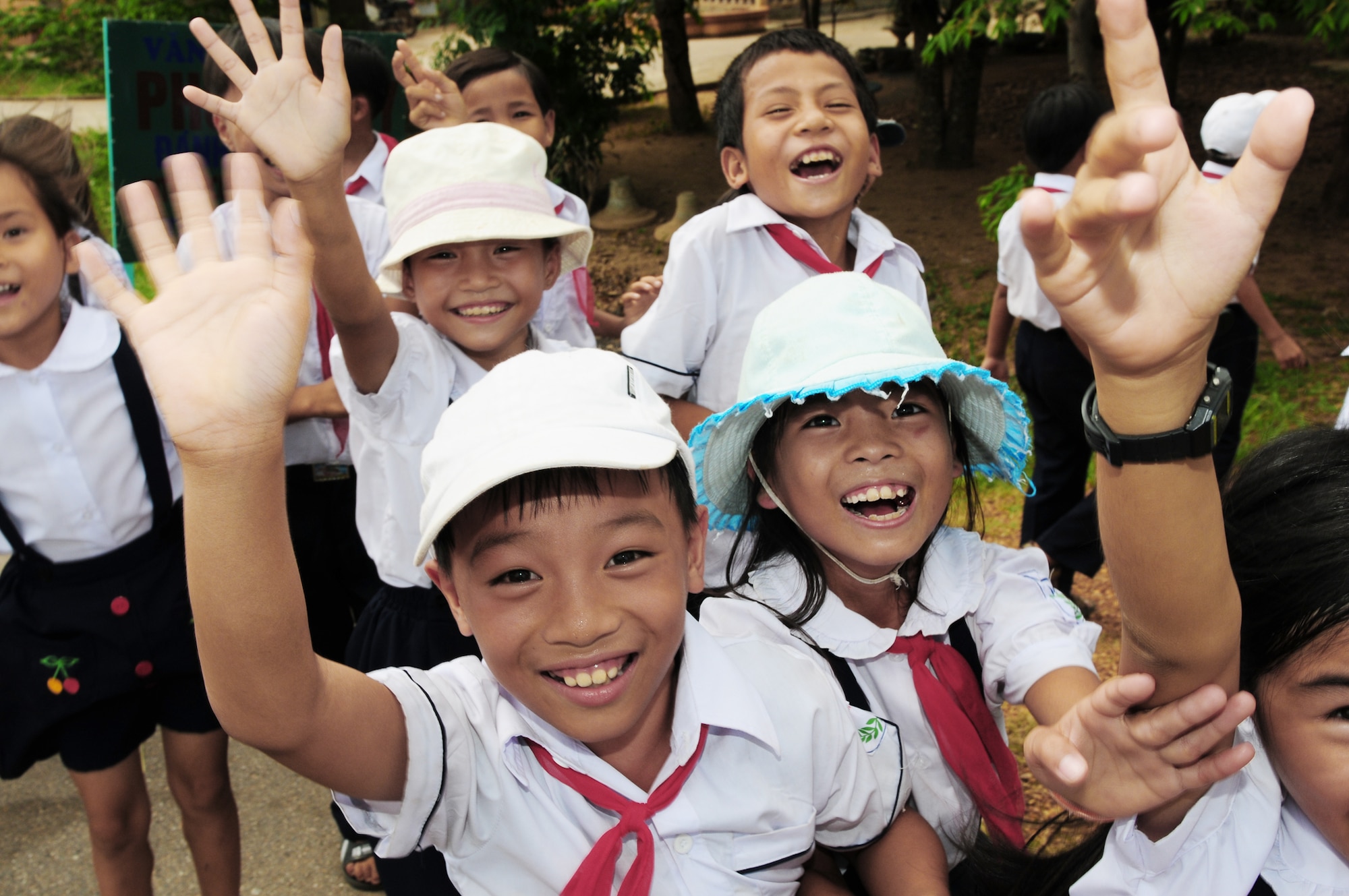 Vietnamese children wave goodbye to Airmen preparing to return to the United States Sept. 22, 2009, after participating in Operation Pacific Angel 2009 in Quang Tri Province, Vietnam. Airmen were in Vietnam Sept. 15 to 24 to provide humanitarian assistance in cooperation with local authorities to area residents. Pacific Angel is a Pacific Air Forces operation led by 13th Air Force at Hickam Air Force Base, Hawaii. (U.S. Air Force photo/Tech. Sgt. Kerry Jackson)