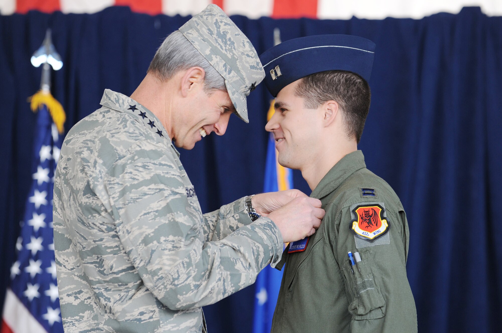 Air Force Chief of Staff Gen. Norton Schwartz presents Capt. Steve Petrizzo, 432nd Wing, his wings during the graduation from initial qualification training at Creech Air Force Base, Nev., Sept. 25, 2009. General Schwartz attended the ceremony as the presiding officer for the first UAS graduation. (U.S. Air Force photo/Airman 1st Class Brett Clashman)

