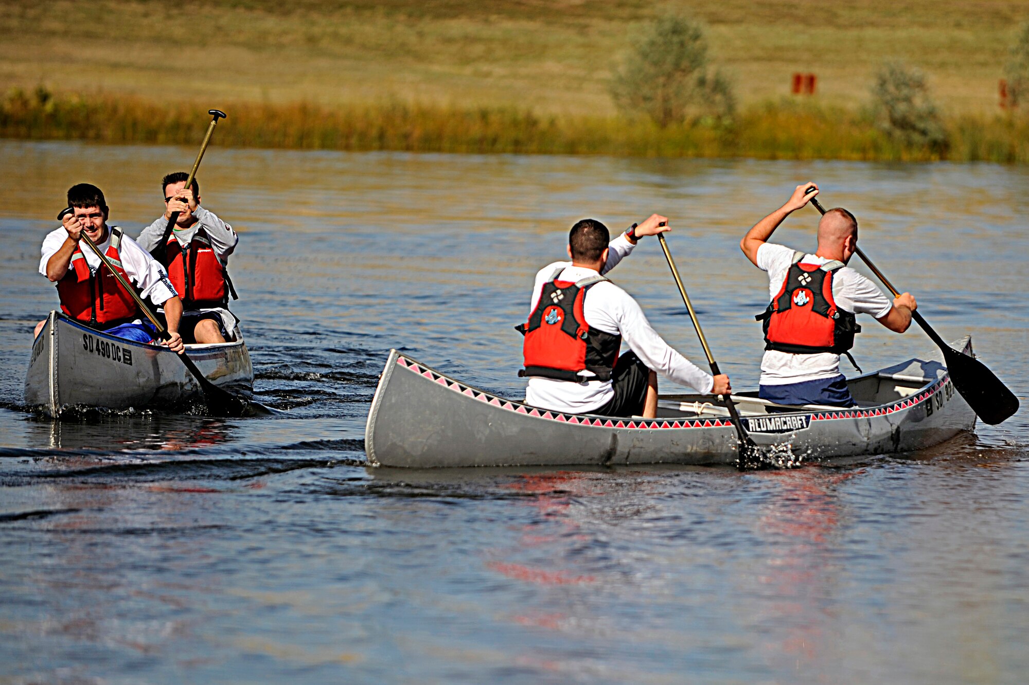 Competitors of the Raider Challenge pass each other during the canoe stage of the race here, Sept. 25. The race had eight checkpoints that contained the location of where they had to go next. (U.S. Air Force photo/Airman 1st Class Matthew Flynn)