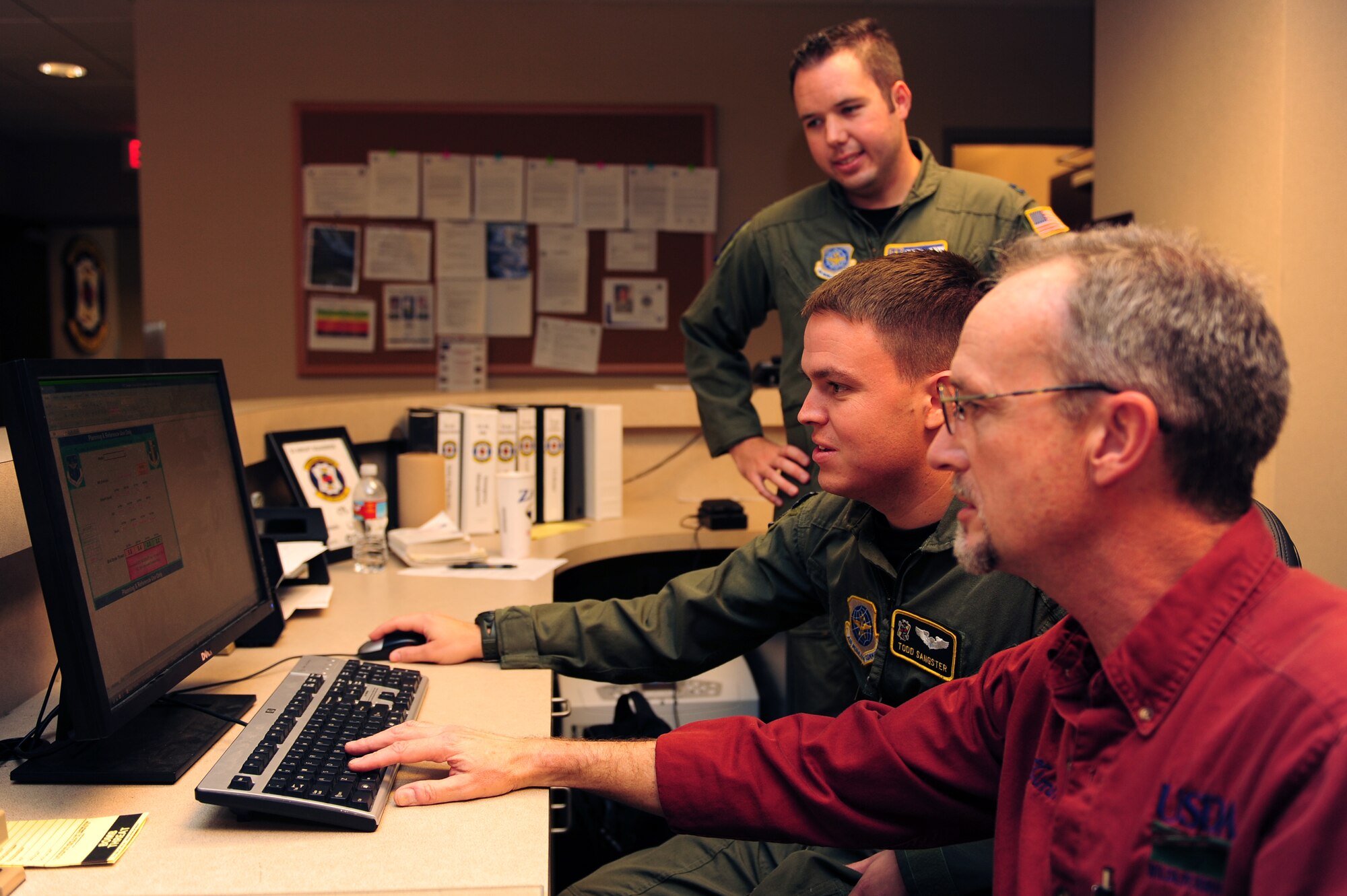 Kimm Hunt, 19th Airlift Wing flight safety wildlife biologist, along with Capt. Todd Sangster, 53rd Airlift Squadron duty officer (center), and Capt. Mike Vyn, 19th Airlift Wing safety officer, catalog various bird strike coordinates Sept. 23. Mr. Hunt created the bird strike calculator to aid in eliminating aircraft bird strikes and the catalog tracks the strikes that occur throughout the year in Arkansas. (US Air Force photo by Senior Airman Jim Araos)