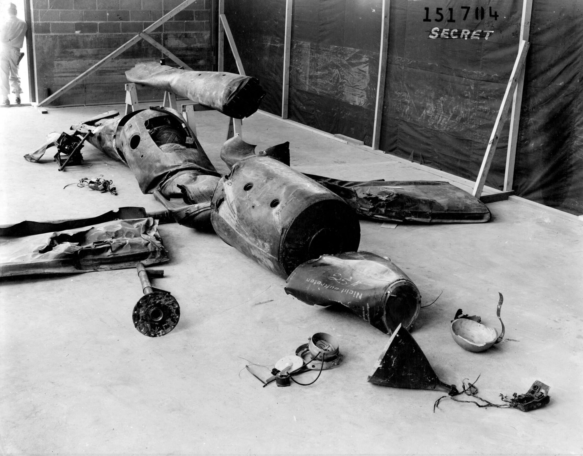 Parts of downed V-1s were assembled and studied closely. Note the armed guard at the upper left and "SECRET" stamp on upper right. (U.S. Air Force photo)