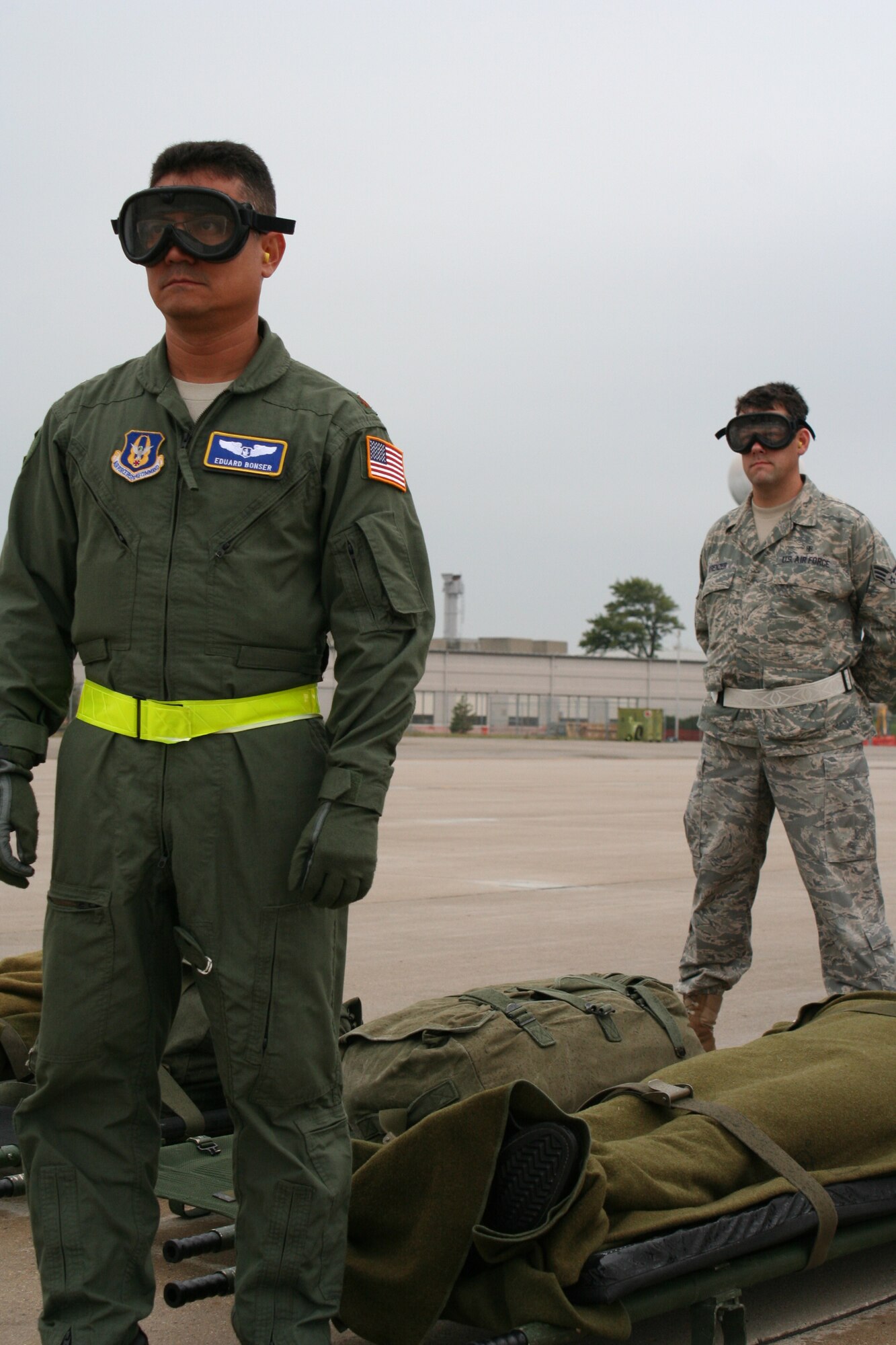 WRIGHT-PATTERSON AIR FORCE BASE, Ohio - Maj. Eduard Bonser and Senior Airman Wolfgang Krenzer, both from the 445th Aeromedical Evacuation Squadron, await the signal from the aeromedical evacuation operations officer to transfer a litter patient to the aircraft while “hot loading” patients onto a waiting C-130 Hercules from Youngstown Air Reserve Station, Ohio, with its engines running. Sixteen reservists from AES participated in a three-day training event that involved loading and unloading patients and equipment onboard the aircraft and using simulated patients to run medical and aircraft emergency scenarios while in flight. (U. S. Air Force photo/Capt. Rodney McNany) 