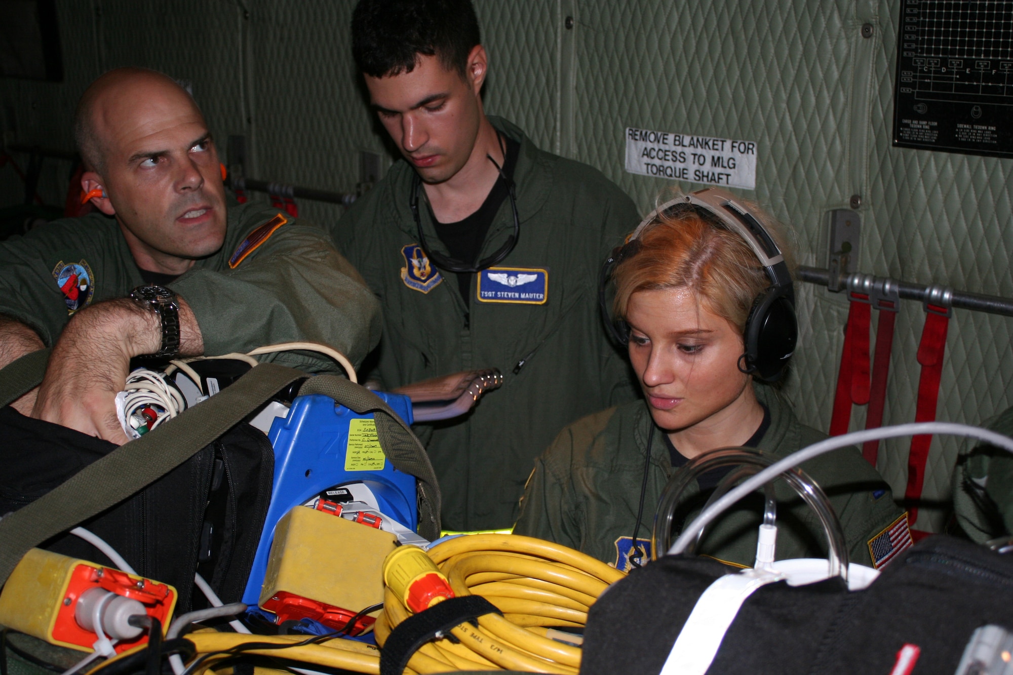 WRIGHT-PATTERSON AIR FORCE BASE, Ohio - Master Sgt.  Dean Keller and Tech. Sgt. Steven Mauter, both from the 445th Aeromedical Evacuation Squadron, along with 1st Lt. Mary Hummel, 911th Aeromedical Squadron, conduct an inventory and visual inspection of medical equipment prior to departing on a medical evacuation training flight. Sixteen reservists from AES participated in a three-day training event that involved loading and unloading patients and equipment onboard the aircraft and using simulated patients to run medical and aircraft emergency scenarios while in flight. (U. S. Air Force photo/Capt. Rodney McNany) 