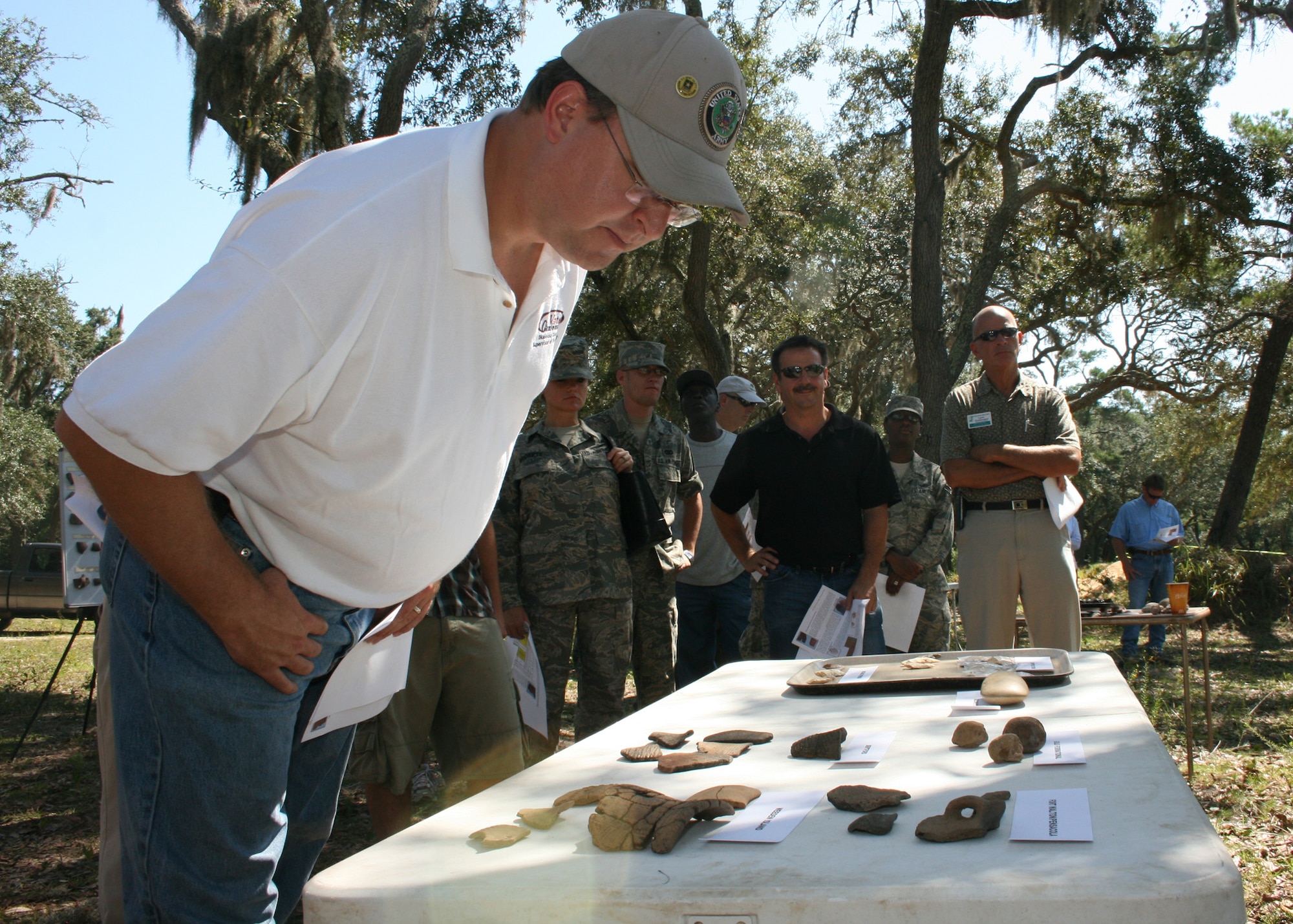 Paul Lux, Okaloosa County Supervisor of Elections, checks out ancient artifacts during a tour of an archeological site on the Eglin reservation Sept. 25. Community leaders and Airmen toured seldom seen parts of Eglin to learn more about the base. A scientific team from the Air Force's cultural resource branch excavates ancient artifacts and pottery in an effort to preserve archeological items found on the reservation. (U.S. Air Force photo/ 2nd Lt. Andrew Caulk.)