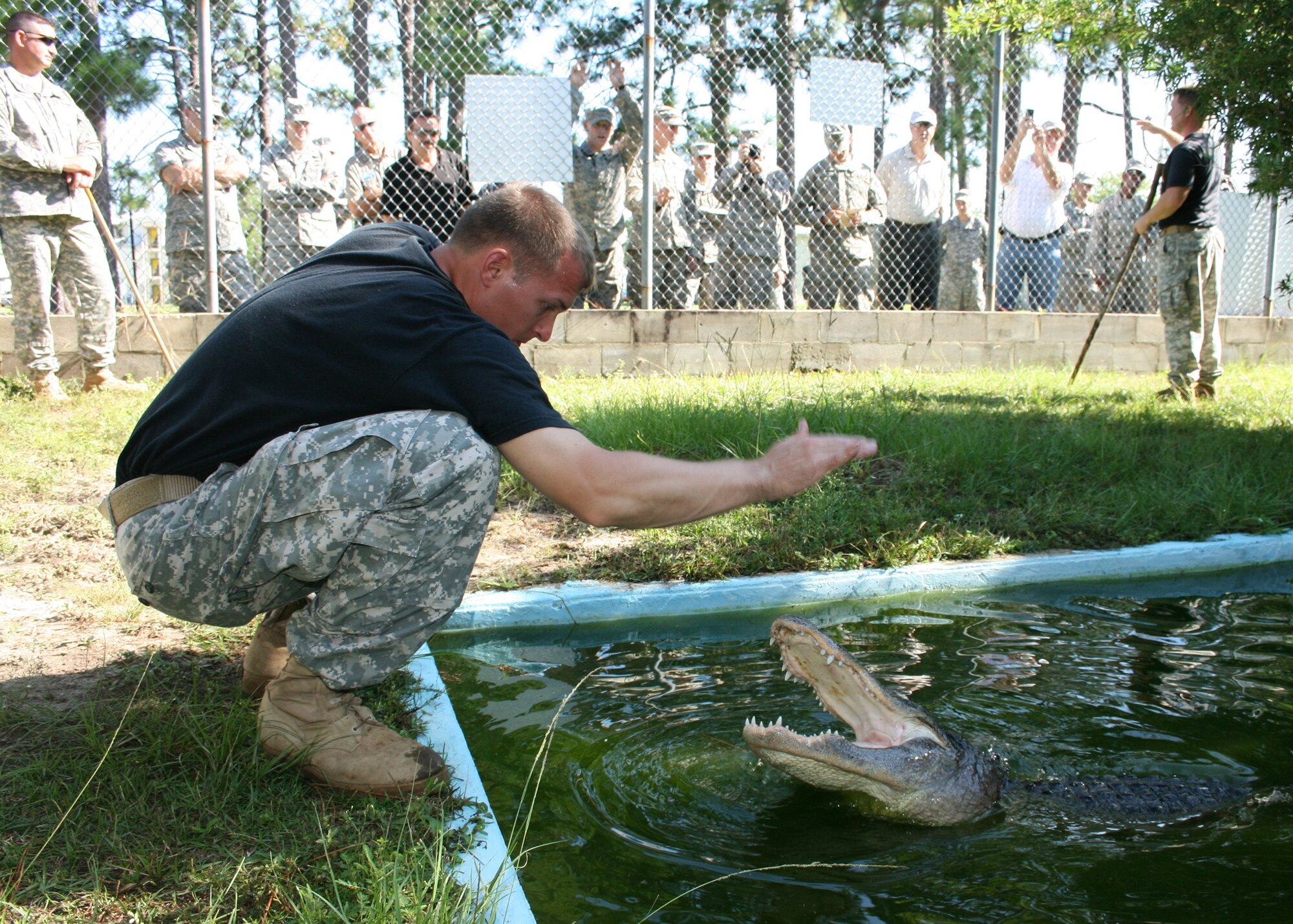 Staff Sgt. Anthony Johnson, 6th Ranger Training Battalion, performs an alligator demo during a tour for community leaders and Airmen of seldom seen sites on the Eglin reservation. Attendees saw the "snake show" at the 6th RTB, which featured venomous and non-venomous snakes and alligators. The purpose of the program is to educate Army Rangers and the public about Florida wildlife. (U.S. Air Force photo/2nd Lt. Andrew Caulk.)