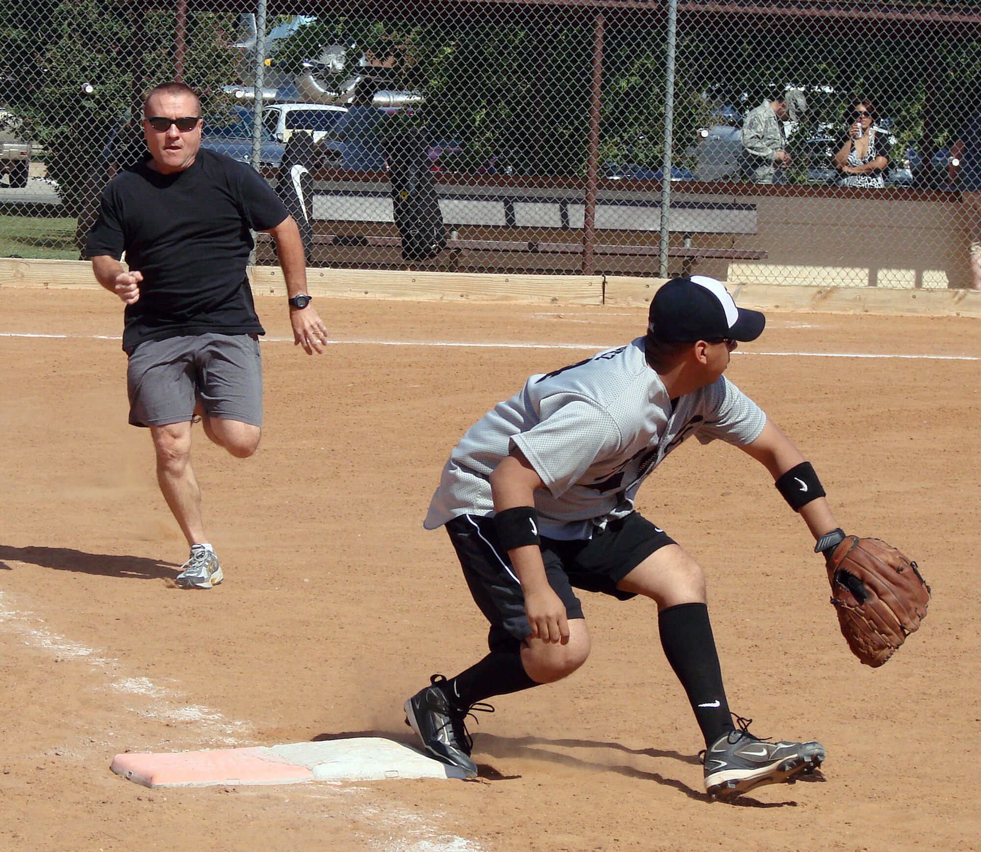 Lt. Col. Royce Terry, 71st Medical Operations Squadron commander, beats out the ball to first base, despite the best effort of Staff Sgt. Joe Lopez, during the Focus 5/6 Softball Challenge held Sept. 25 on base field No. 1. (U.S. Air Force photo/ Joe B. Wiles)