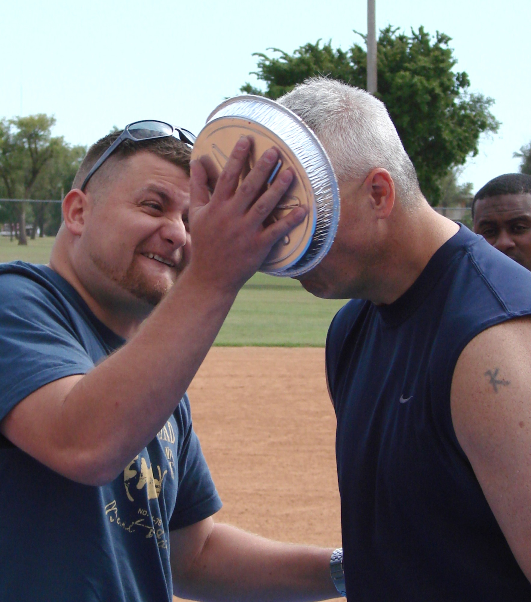 Tech. Sgt. Richard White, 71st Communications Squadron, plants a pie on Chief Master Sgt. M. Kenui Balutski, the 71st Flying Training Wing command chief, following the Focus 5/6 Softball Challenge held Sept. 25 on ball field No. 1. The Focus 5/6 donated $650 raised during the pie-in-the-face event to “Friends of Vance Families,” a local Combined Federal Campaign organization. (U.S. Air Force photo/ Joe B. Wiles)