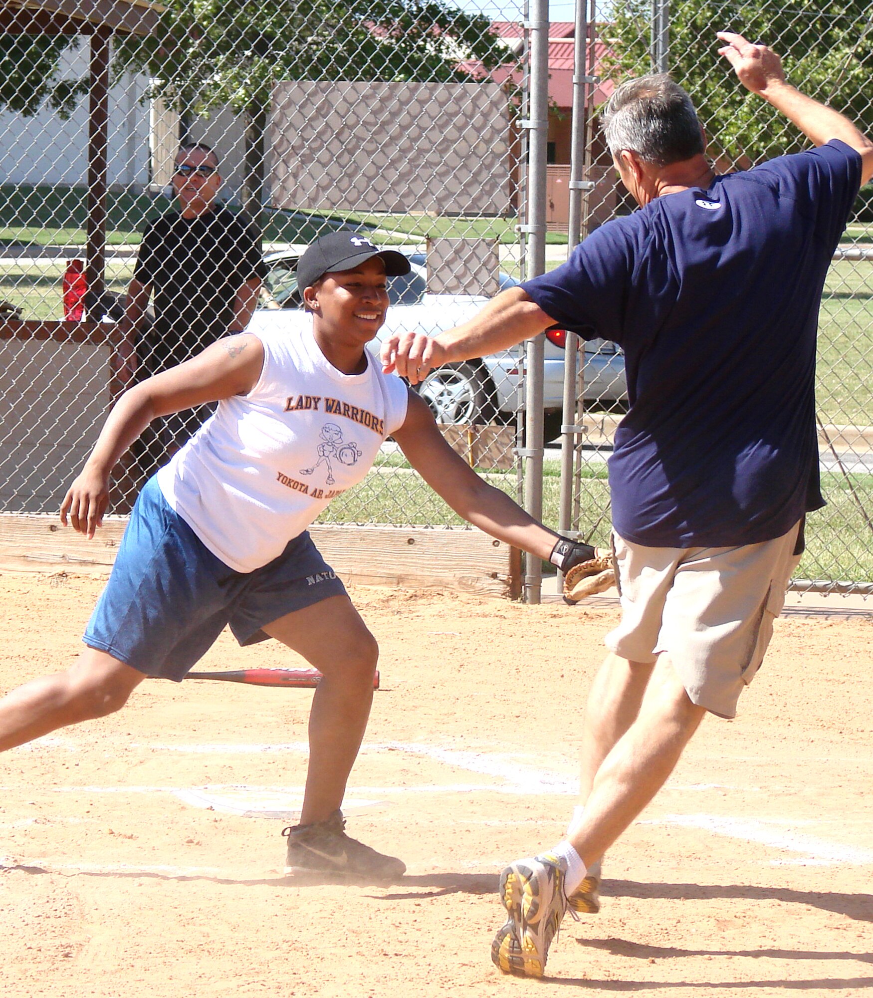 Staff Sgt. Crystal Hardy tags out Col. Chris Nowland, 71st Flying Training Wing commander, at home plate in the bottom of the first inning of the Focus 5/6 Softball Challenge played Sept. 25 on base field No. 1. Junior enlisted took on senior leadership to raise money for the 2009 Vance Combined Federal Campaign. (U.S. Air Force photo/ Joe B. Wiles)