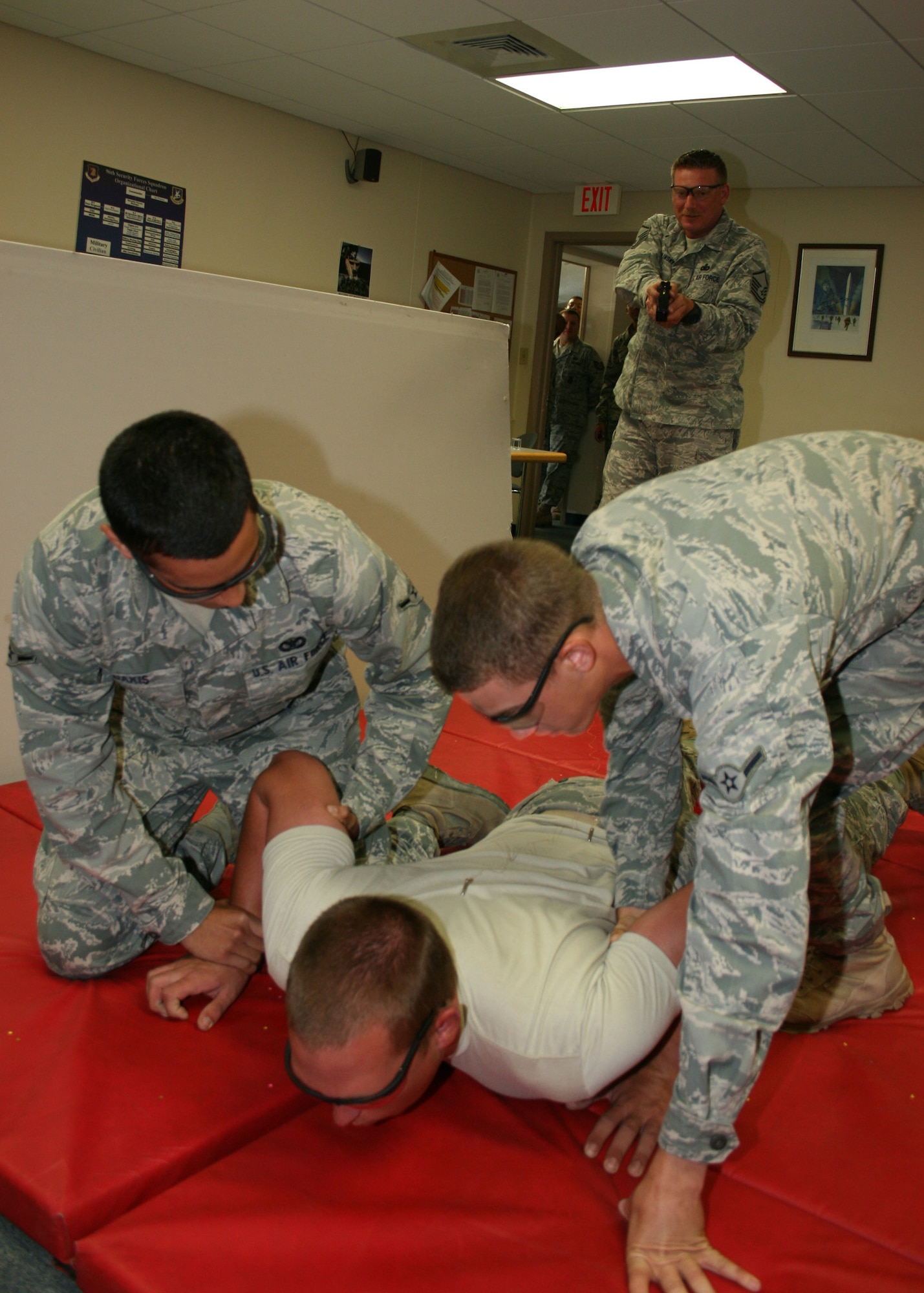 Airman 1st Class Christopher Rousselle, 96th Security Forces Squadron, gets tazed while completing his tazer training.  SFS members who choose to carry the tazer as their non-lethal weapon must first be tazed so they understand the repercussions of the use of force.  Members complete 30 days of training each year to maintain proficiency in various aspects of their career field. (U.S. Air Force photo/ 2nd Lt. Andrew Caulk.)