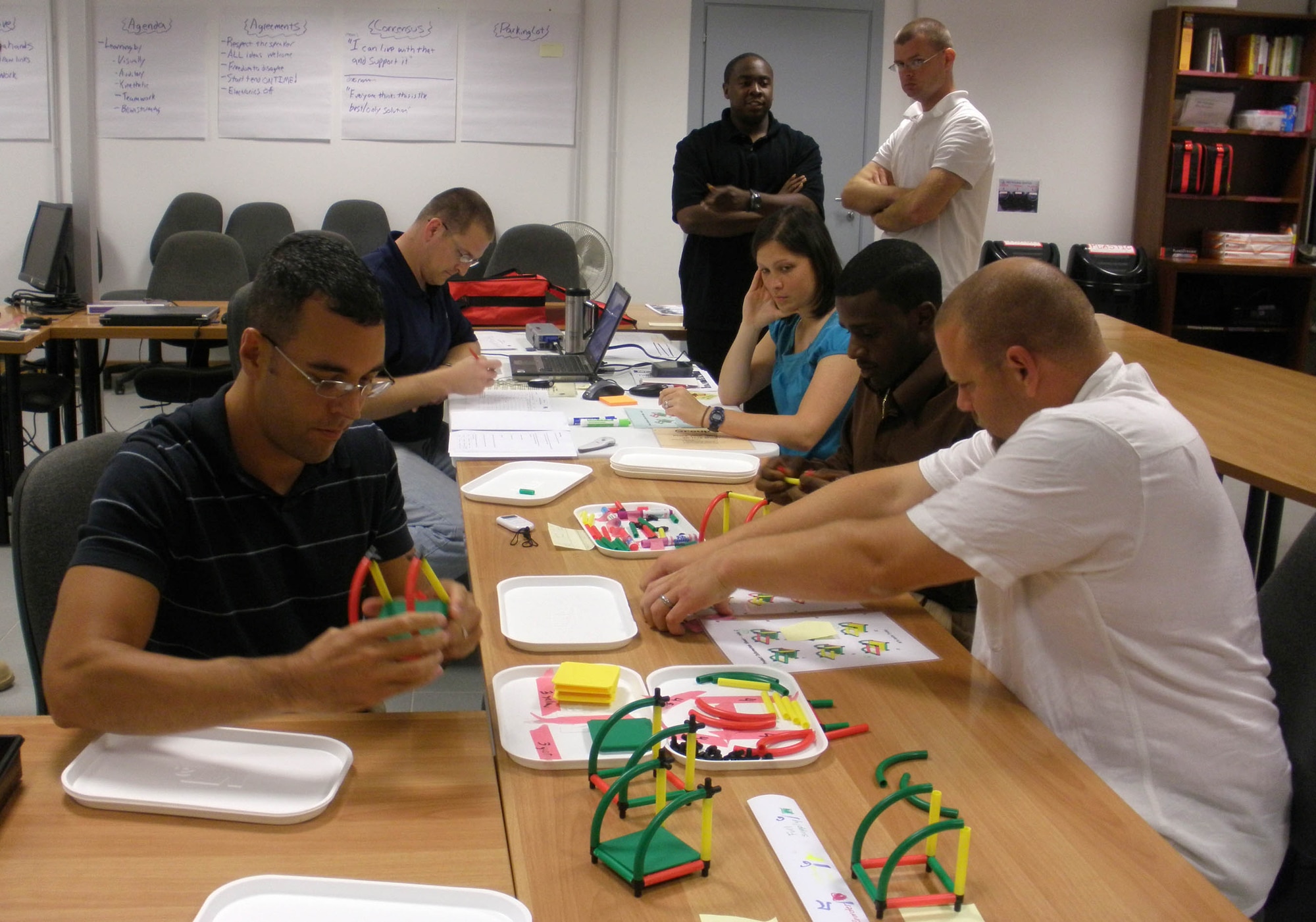 Airmen work together to meet customer demand as part of a KanDo Lean class exercise Sept. 11, 2009, at Aviano Air Base, Italy. The class, which is offered through the Air Force Smart Operations 21 office here, allows attendees to receive training in a team-based environment to discover how to remove waste from a simulated process and relate that to what they do every day through active execution and discussion. (U.S. Air Force photo/Master Sgt. Gregory Craig)
