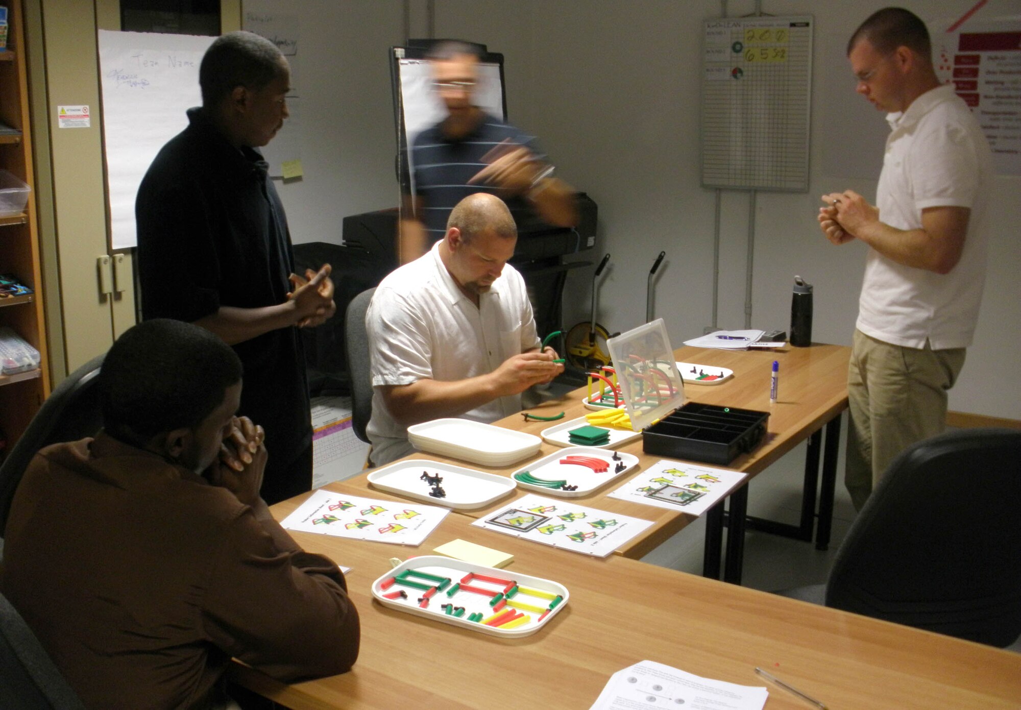 Airmen participate in a widget-building exercise during a KanDo Lean class Sept. 11, 2009, at Aviano Air Base, Italy. The class, which is offered through the Air Force Smart Operations 21 office here, allows attendees to receive training in a team-based environment to discover how to remove waste from a simulated process and relate that to what they do every day through active execution and discussion. (U.S. Air Force photo/Master Sgt. Gregory Craig)      