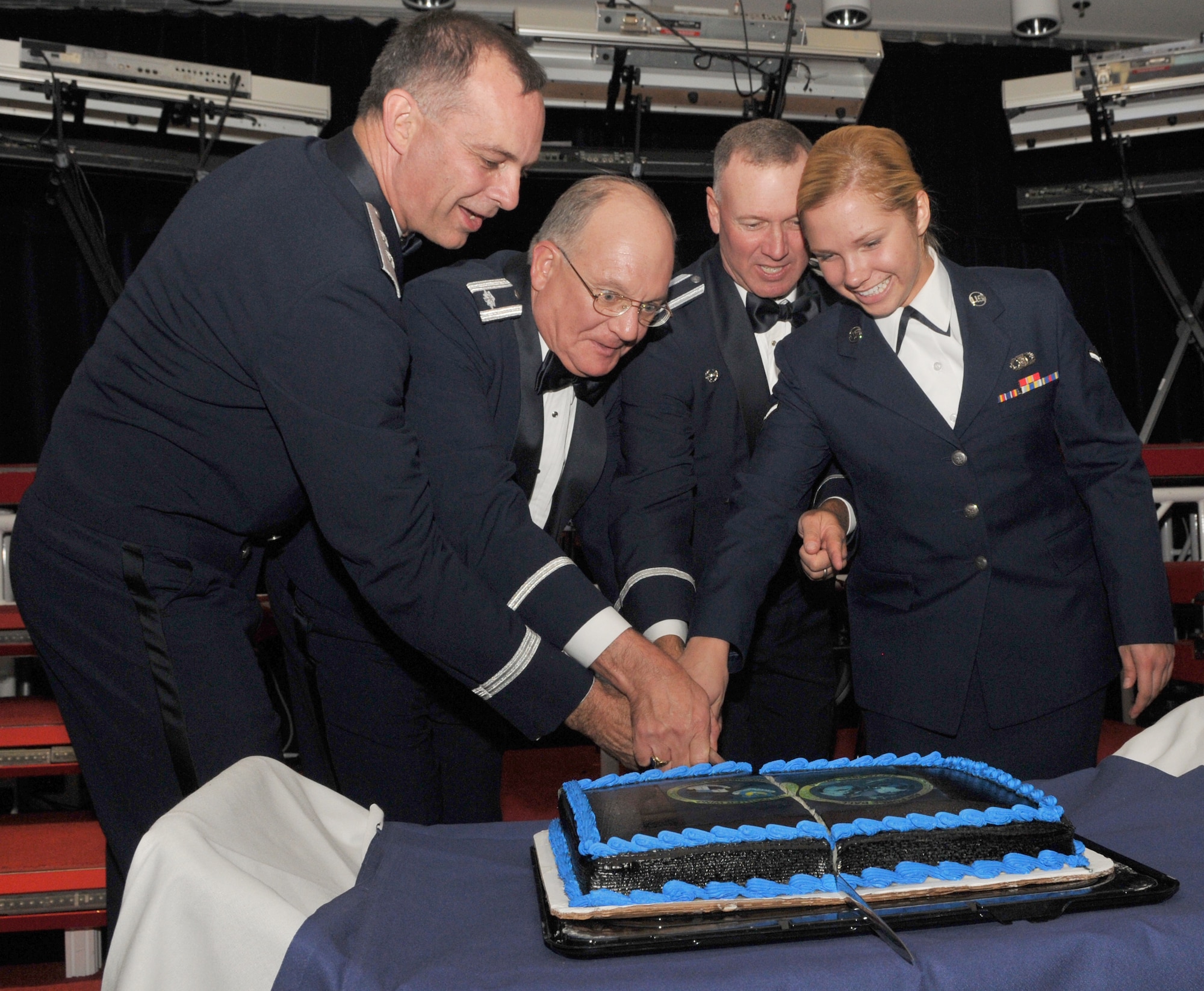 SPANGDAHLEM AIR BASE Germany -- 3rd Air Force Vice Commander Maj. Gen. Mark Zamzow, retired Lt. Col. Charles McDonald, 52nd Fighter Wing Judicial Administration, 52nd Fighter Wing Commander Colonel Tip Wight and Airman Leah Semik, 606th Air Control Squadron, hold the ceremonial Saber and cut the cake during the 2009 Air Force Ball here at Club Eifel Sept. 25. Traditionally, at this base, the youngest Airman and the 52nd FW commander cut the cake during base wide ceremonies. During this ceremony, both the youngest and oldest member of the 52nd Fighter Wing cut the cake together. (U.S. Air Force photo/Airman 1st Class Nick Wilson)