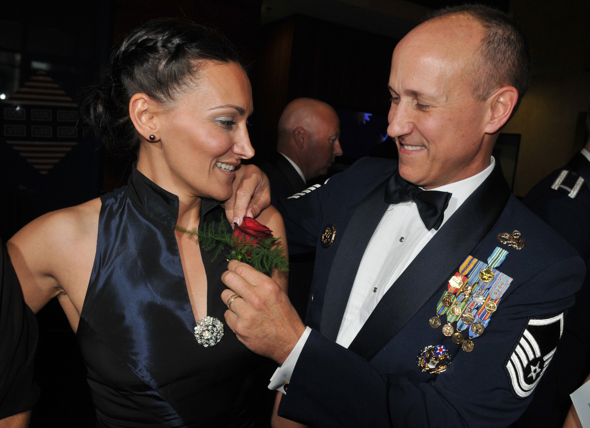SPANGDAHLEM AIR BASE Germany -- Master Sgt.  Allan Kendrick, 52nd Fighter Wing Air Force Smart Operations for the 21st Century, puts a corsage on Teresa Garrett during the 2009 Air Force Ball here at Club Eifel Sept. 25. Sabers from across the 52nd Fighter Wing were invited to attend the event, which observed the Air Force's birthday and Airmen's contributions around the globe.  This year's theme was "All in...Globally Engaged" to recognize the unique role the Air Force fulfills in missions across the world. (U.S. Air Force photo/Airman 1st Class Nick Wilson)