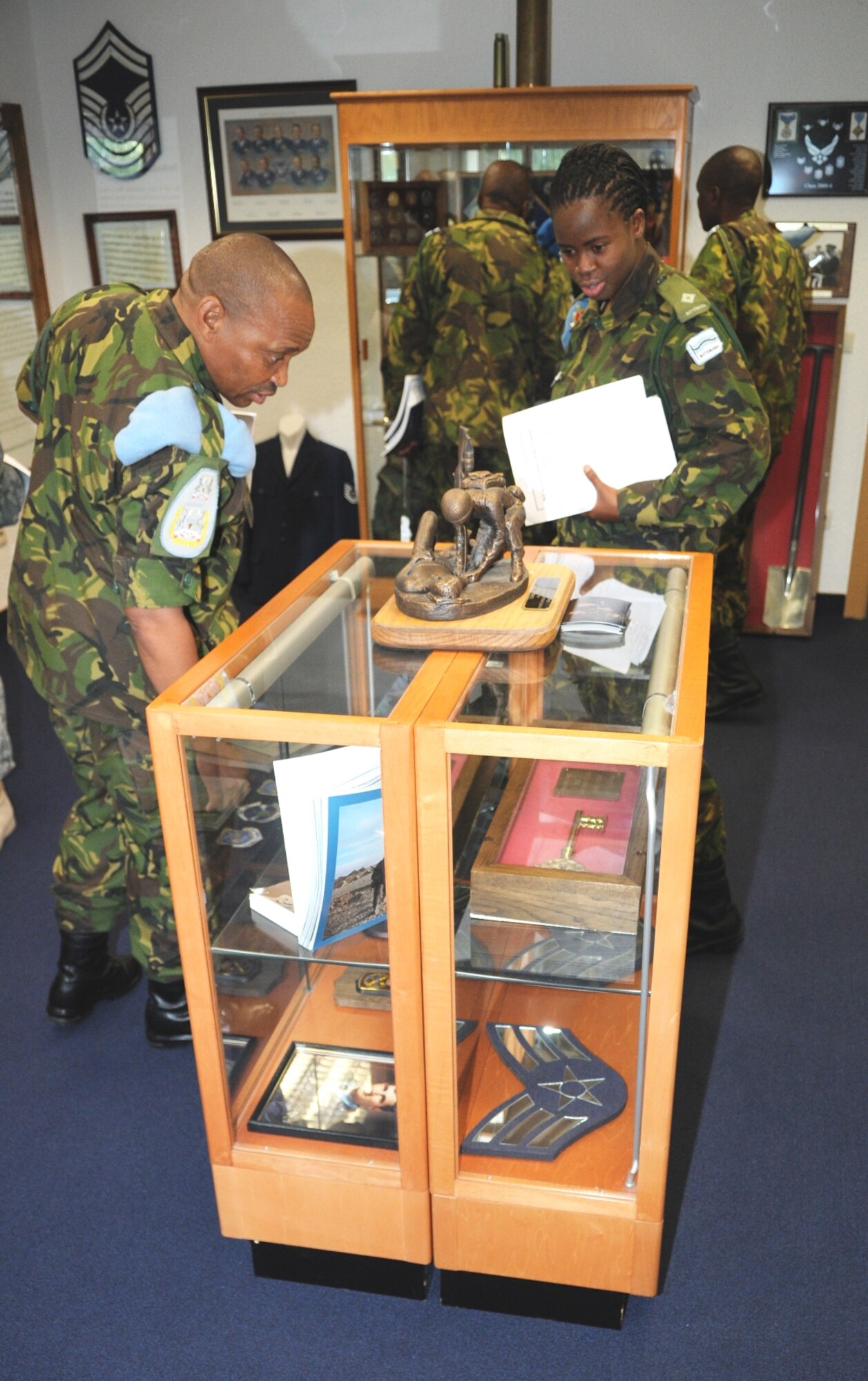 VOGELWEH BASE, Germany -- Botswana Forces Military Command Sergeant Major Mogakolodi Sebego (left) and 2nd. Lt. Lesedi Kelesitse view the enlisted heritage display at the Airman Leadership School here Sept. 22. The Botswana delegation was visiting 17th Air Force at Ramstein on a familiarization engagement from Sept. 21-24, which included a series of orientations, tours and panel discussions focused on development of the enlisted force. The visit also included stops at the USAFE NCO Academy, and the 86th Contingency Response Group, among others. (USAF photo by Master Sgt. Jim Fisher) 