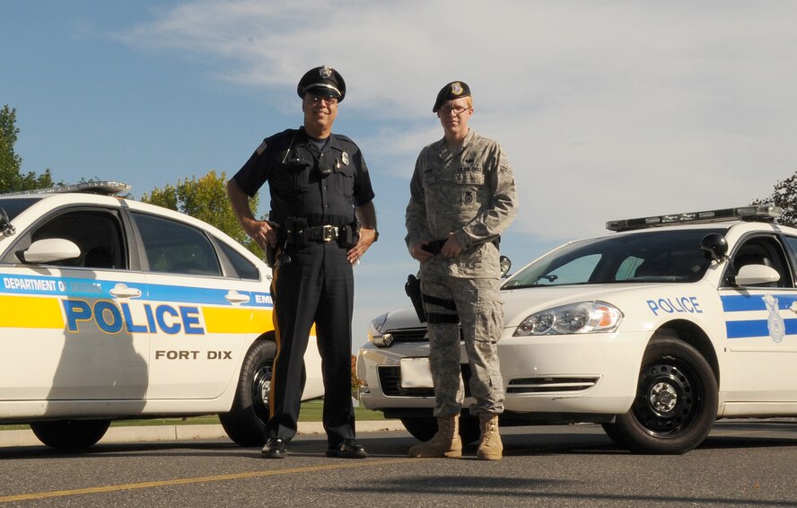 Randall Calderon Sr., Department of Defense Police patrolman at Fort Dix for five years and retired Army first sergeant, and Airman 1st Class Alexander McPeake, 87th Security Forces Squadron patrolman, are working together to ensure the safety and security of Joint Base McGuire-Dix-Lakehurst, N.J. (U.S. Air Force Photo Illustration/Staff Sgt. Danielle Johnson)