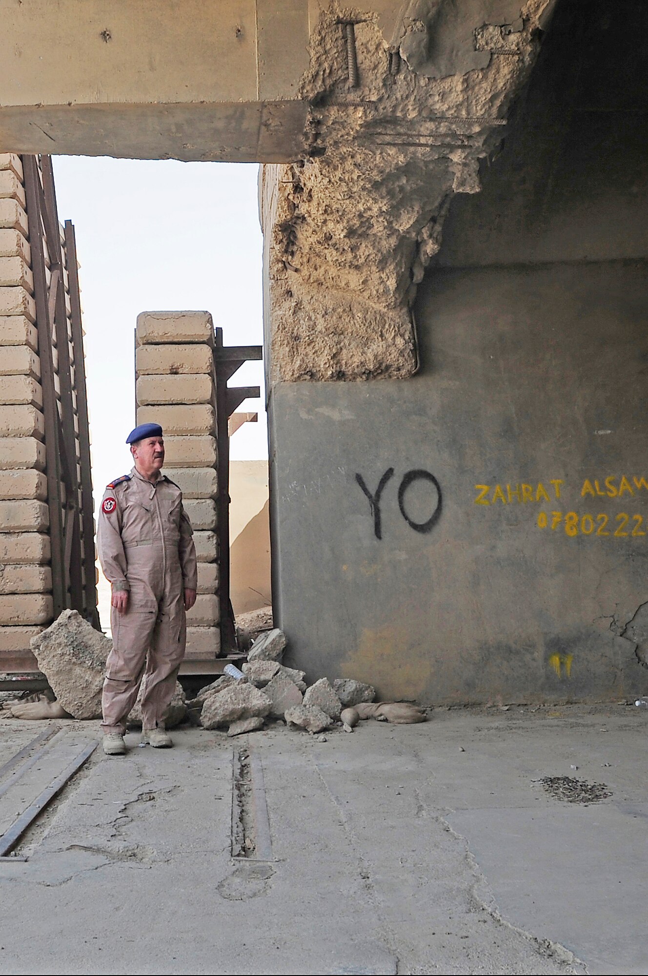 Iraqi air force Commander Staff Lt. Gen. Anwar Hamad Amen Ahmed surveys an aircraft hangar that is in need of repair during his visit Sept. 24, 2009, at Ali Base, Iraq. The visit by General Anwar to Ali Base marked a significant step in providing the Iraqi air force with a better understanding of what assets will be available to support them here when the base is transitioned to government of Iraq. (U.S. Air Force photo/Senior Airman Tony R. Ritter) 
