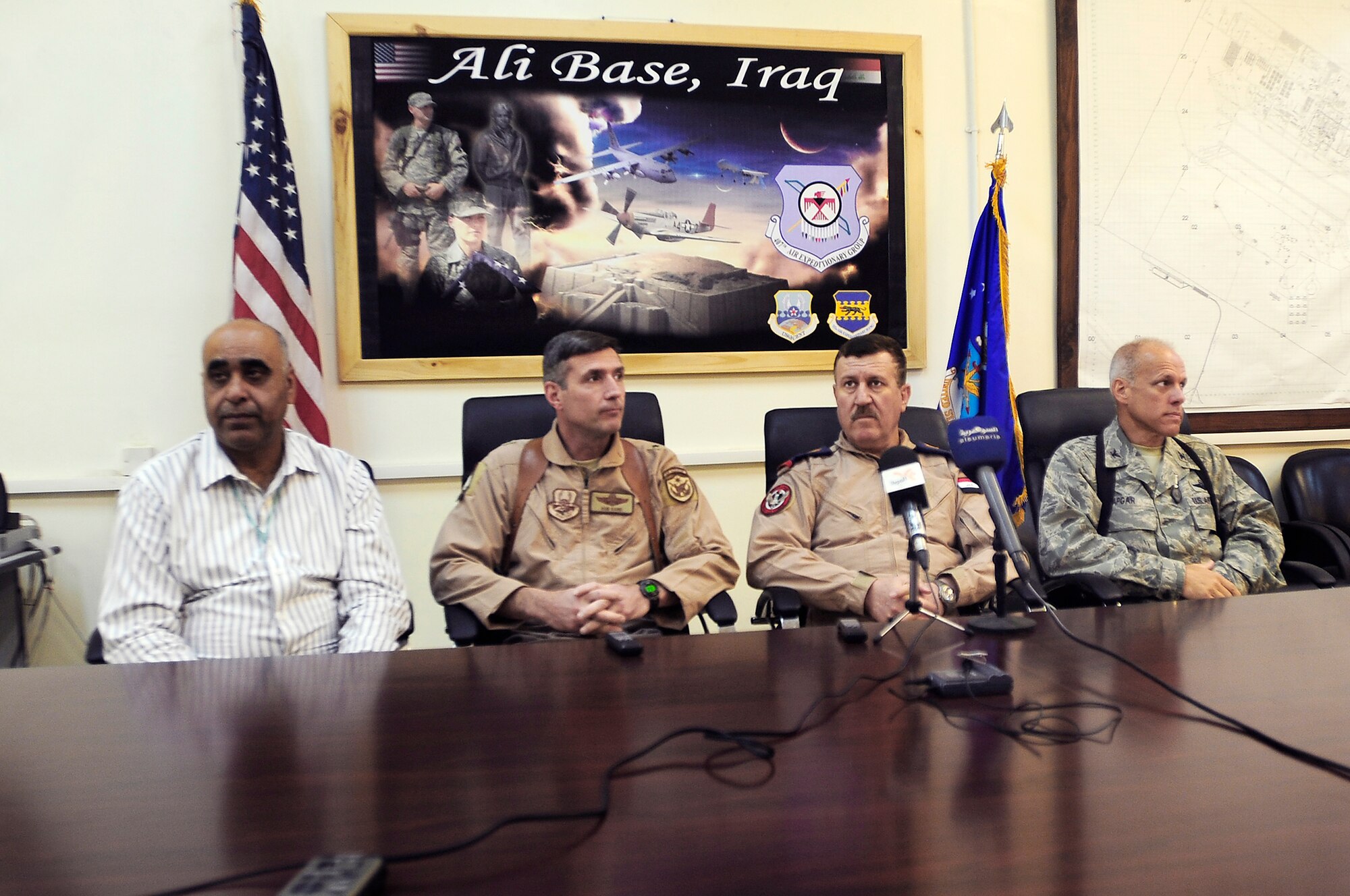 An Iraqi interpreter (left to right), Maj. Gen. Robert Kane, Iraqi air force Commander Staff Lt. Gen. Anwar Hamad Amen Ahmed and Col. Glen Apgar conduct a question and answer session with Iraqi media Sept. 24, 2009, at Ali Base, Iraq. General Kane is the director, Iraq Training and Advisory Mission - Air Force, and Colonel Apgar is the 407th Air Expeditionary Group commander. (U.S. Air Force photo/Senior Airman Tony R. Ritter) 
