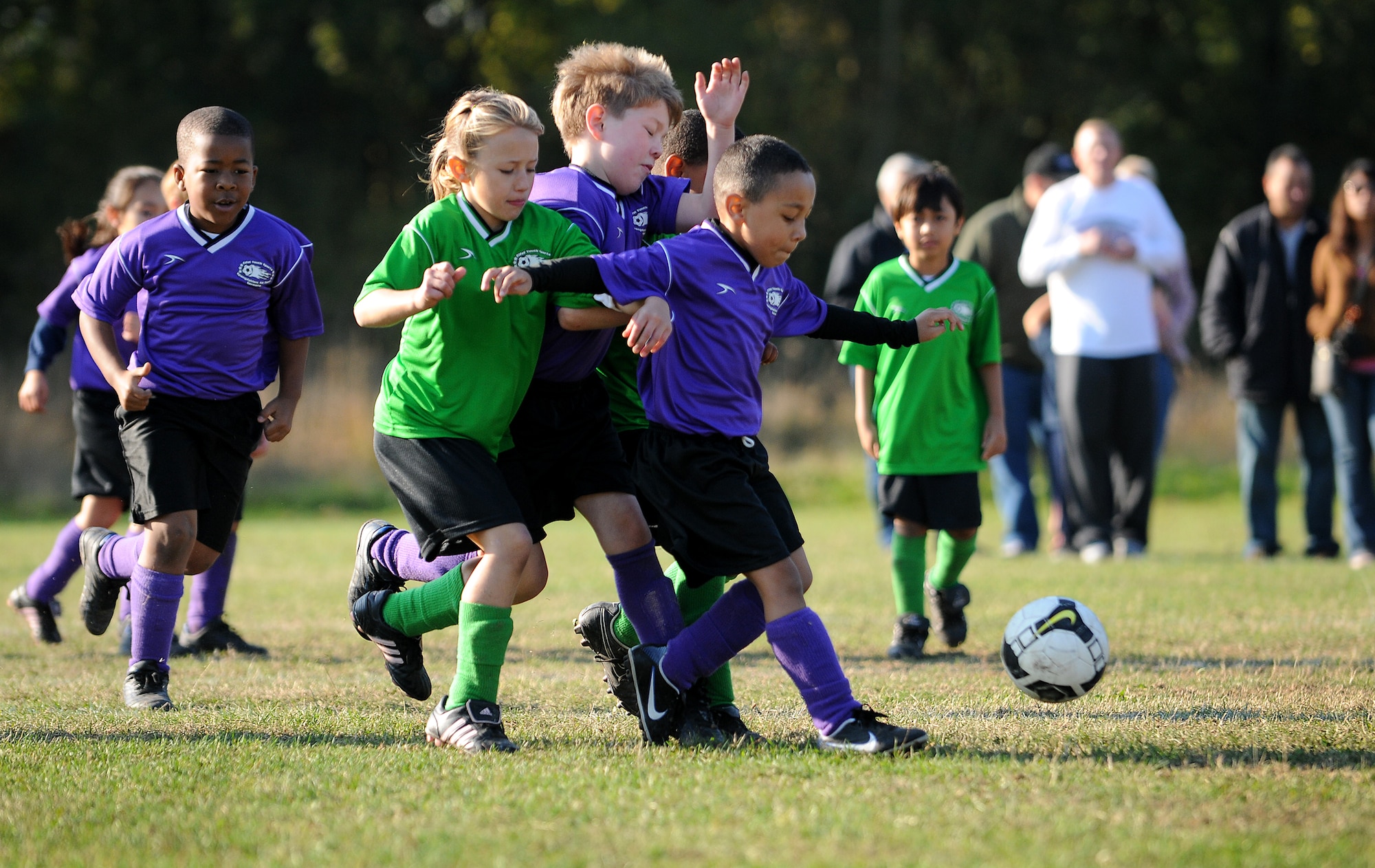 SPANGDAHLEM AIR BASE, Germany -- Members of the Sabers (green) and Galaxy (purple) race after the soccer ball during a youth soccer game on Spangdahlem’s soccer fields Sept. 26. The youth soccer season started Aug. 24. and runs until Oct. 24. (U.S. Air Force photo/Airman 1st Class Nathanael Callon)