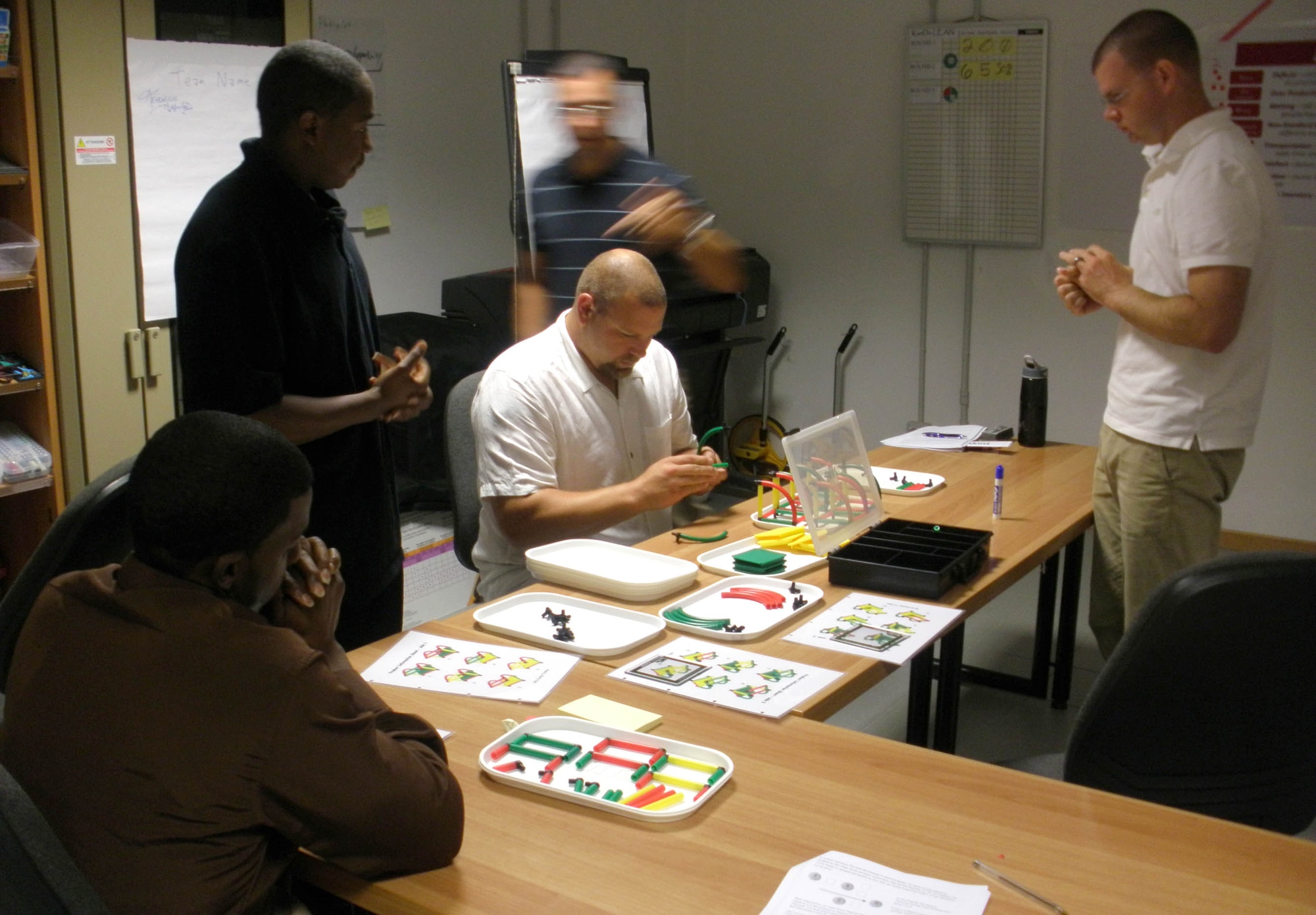 Participants undergo a widget-building exercise during a KanDo Lean class Sept. 11, 2009 at Aviano Air Base, Italy. The class, which is offered through the Air Force Smart Operations 21 office here, allows attendees to receive training in a team based environment to discover how to remove waste from a simulated process and relate it to what they do every day through active execution and discussion. (U.S. Air Force photo/Master Sgt. Craig Gregory)      