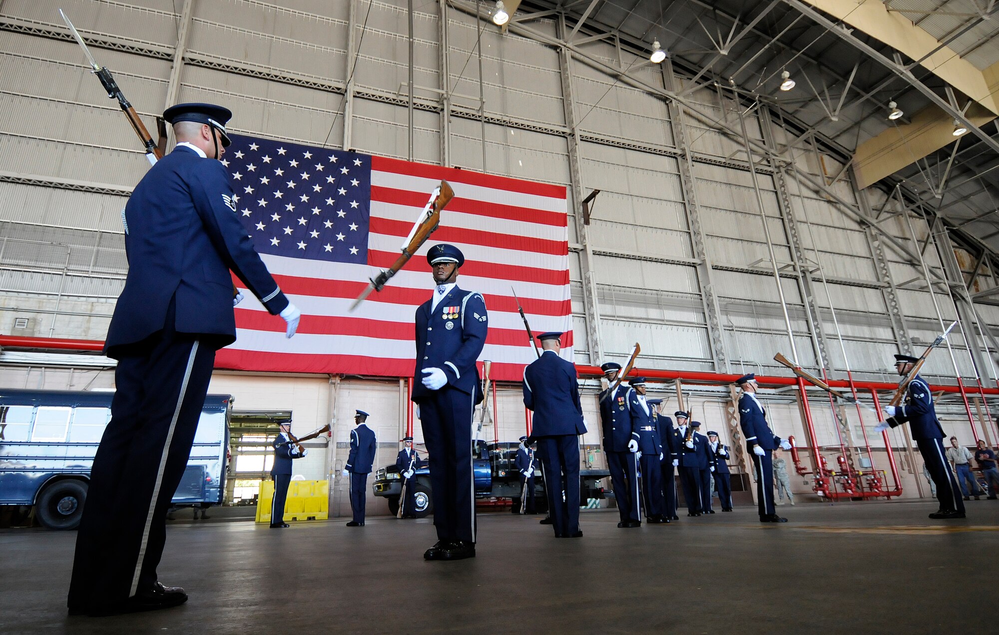 Staff Sgt. Michael Doss, Air Force Honor Guard Drill Team NCO in charge, throws an “under” to Senior Airman Eddie Moses during a 16-man drill team performance Sept. 25 at Hickam Air Force Base, Hawaii. The Drill Team is the traveling component of the U.S. Air Force Honor Guard and tours worldwide representing all Airmen while showcasing Air Force precision and professionalism. (U.S. Air Force photo by Staff Sgt. Dan DeCook)