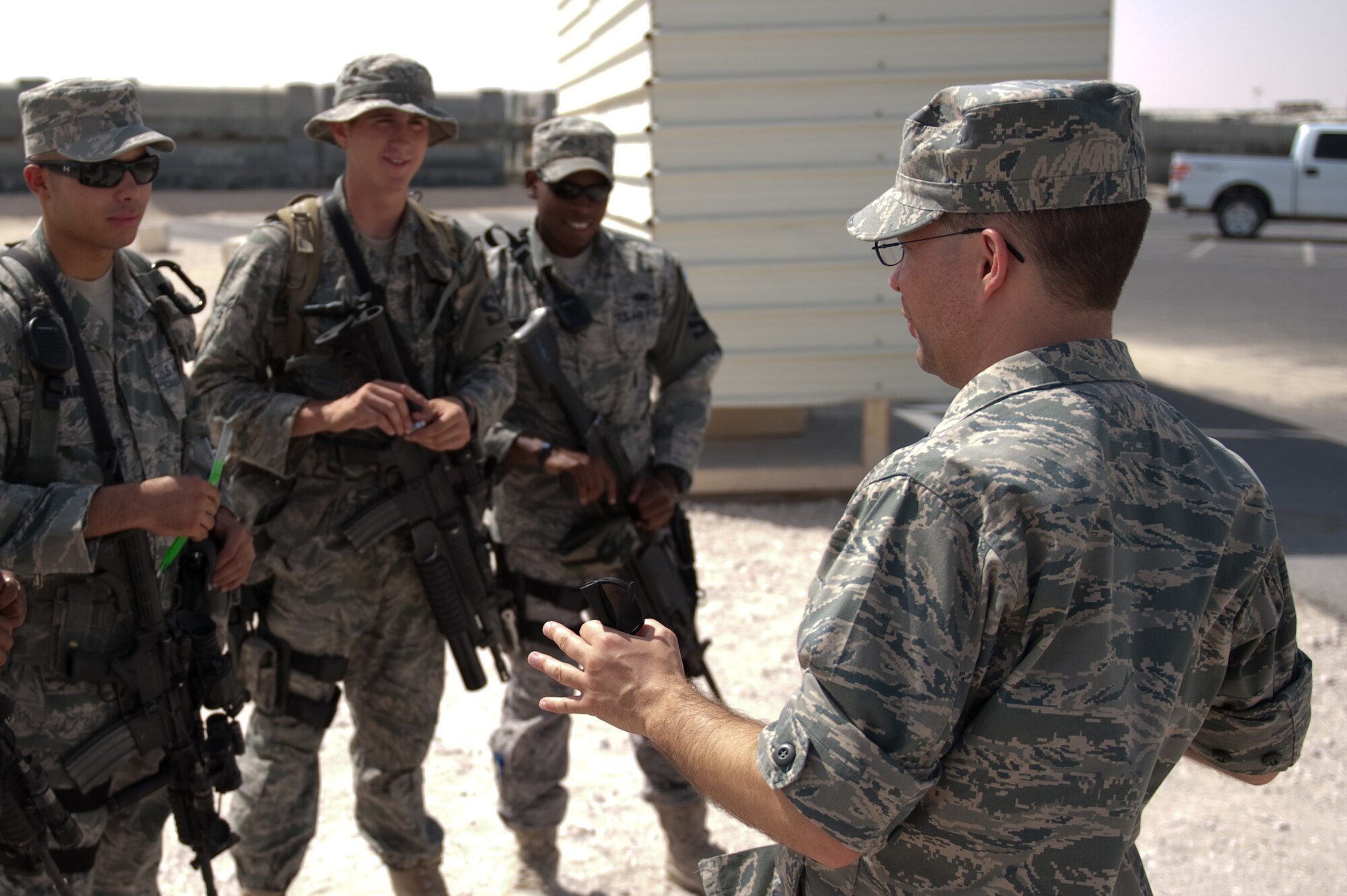 Right, Chaplain (Capt.) Mark Juchter, 379th Air Expeditionary Wing, visits with members of the 379th Expeditionary Security Forces Squadron, Sept. 24, in Southwest Asia. Chaplain Juchter leads the weekly traditional Protestant service and visits regularly with Airmen around the base. Chaplain Juchter is deployed from Tinker Air Force Base, Okla., to minister to servicemembers deployed in support of Operations Iraqi and Enduring Freedom. (U.S. Air Force photo/Staff Sgt. Robert Barney) 