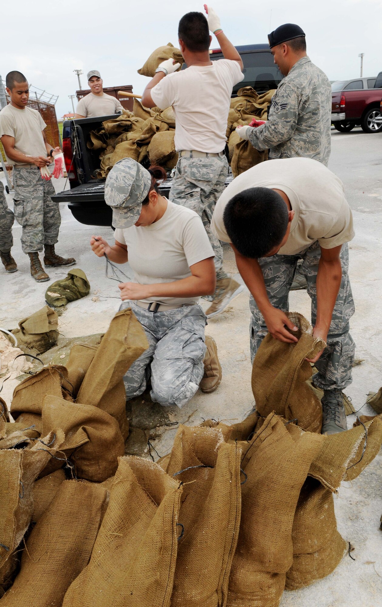 ANDERSEN AIR FORCE BASE, Guam - Airmen from the 254th Security Forces Squadron Guam Air National Guard fill and load sandbags at Andersen's Self Help Store Sept. 28 in preparation for a tropical storm headed for the island. Due to the untimely weather, Andersen leadership canceled the Team Andersen Air Show 2009 scheduled for Sept. 30.  The air show was to feature the United States Air Force Thunderbirds. (U.S. Air Force photo by Senior Airman Nichelle Anderson)