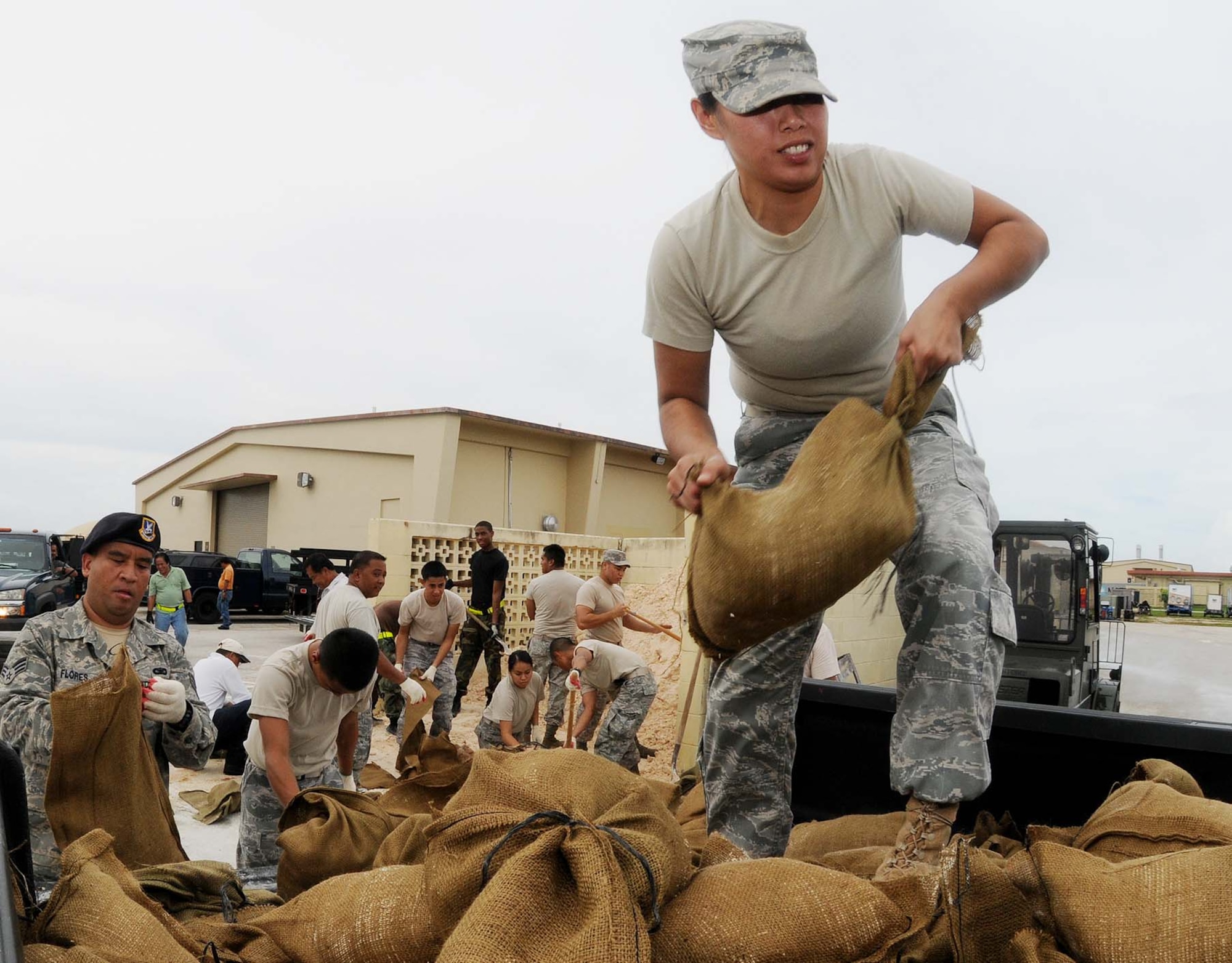 ANDERSEN AIR FORCE BASE, Guam - Airman 1st Class Jolene Muna from the 254th Security Forces Squadron Guam Air National Guard fills and loads sand bags  at Andersen's Self Help Store Sept. 28 in preparation for a tropical storm headed for the island. Due to the untimely weather, Andersen leadership canceled the Team Andersen Air Show 2009 scheduled for Sept. 30, which was to feature the United States Air Force Thunderbirds. (U.S. Air Force photo by Senior Airman Nichelle Anderson)