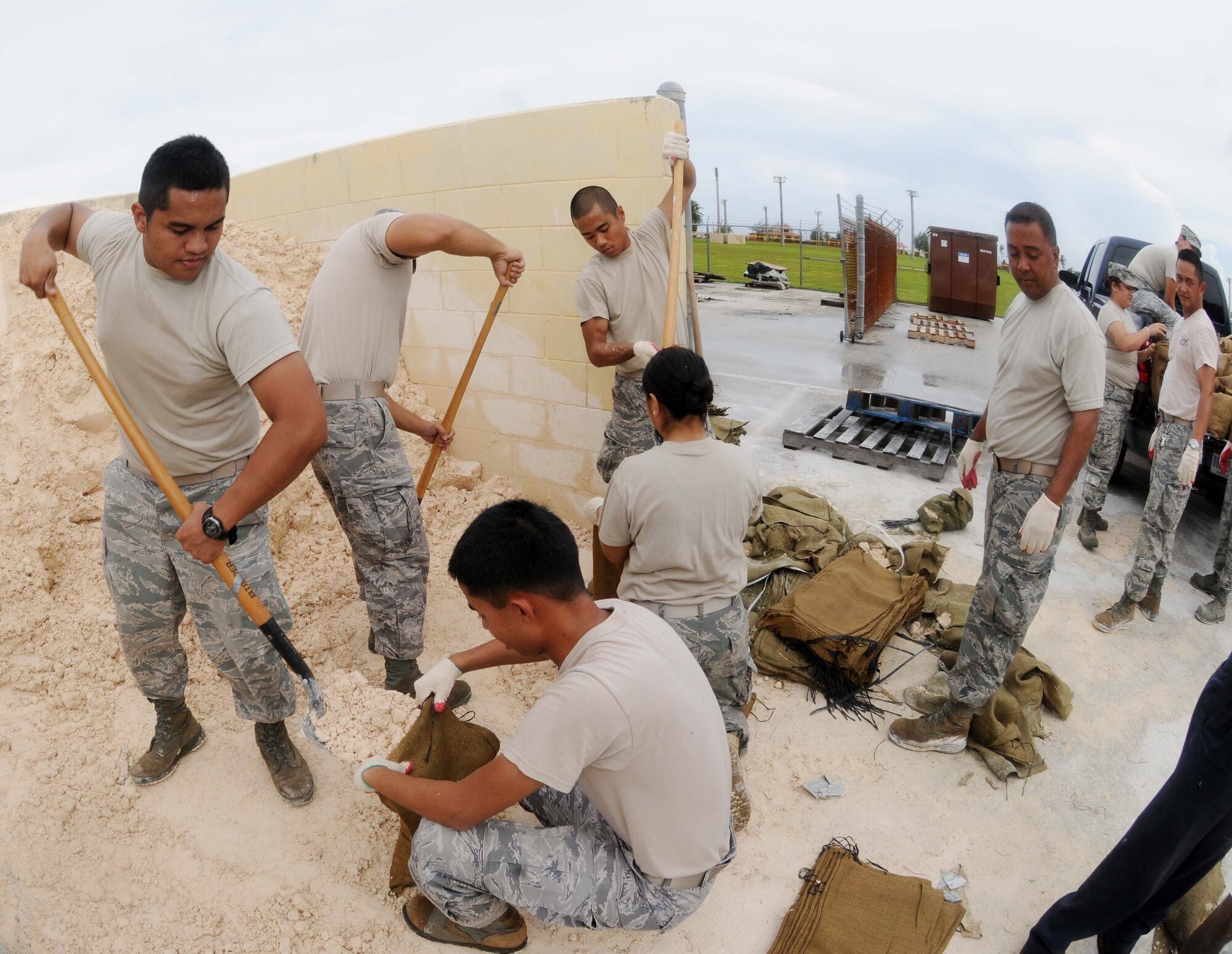 ANDERSEN AIR FORCE BASE, Guam - Airmen from the 254th Security Forces Squadron Guam Air National Guard fill and load sand bags at Andersen's Self Help Store Sept. 28 in preparation for a tropical storm headed for Guam.  Due to the untimely weather, Andersen leadership canceled the Team Andersen Air Show 2009 scheduled for Sept. 30, which was to feature the United States Air Force Thunderbirds. (U.S. Air Force photo by Senior Airman Nichelle Anderson)