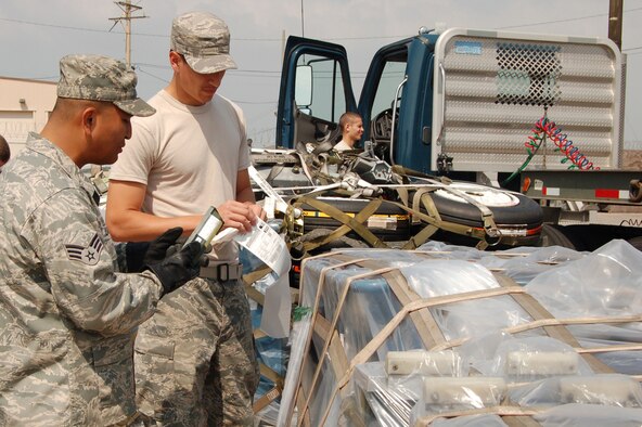 Senior Airmen Arnold Lagajeno and Mark Alvarado, 8th Logistics Readiness Squadron, attach labels to equipment pallets as Airman 1st Class Jacob Josleyn prepares to transport the pallets. The pallets head to exercises Distant Frontier and Red Flag-Alaska. Distant These exercises provide an operations training environment for aircrews, maintenance crews, command and control elements and intelligence experts. (U.S. Air Force photo/Master Sgt. Anna Hayman)