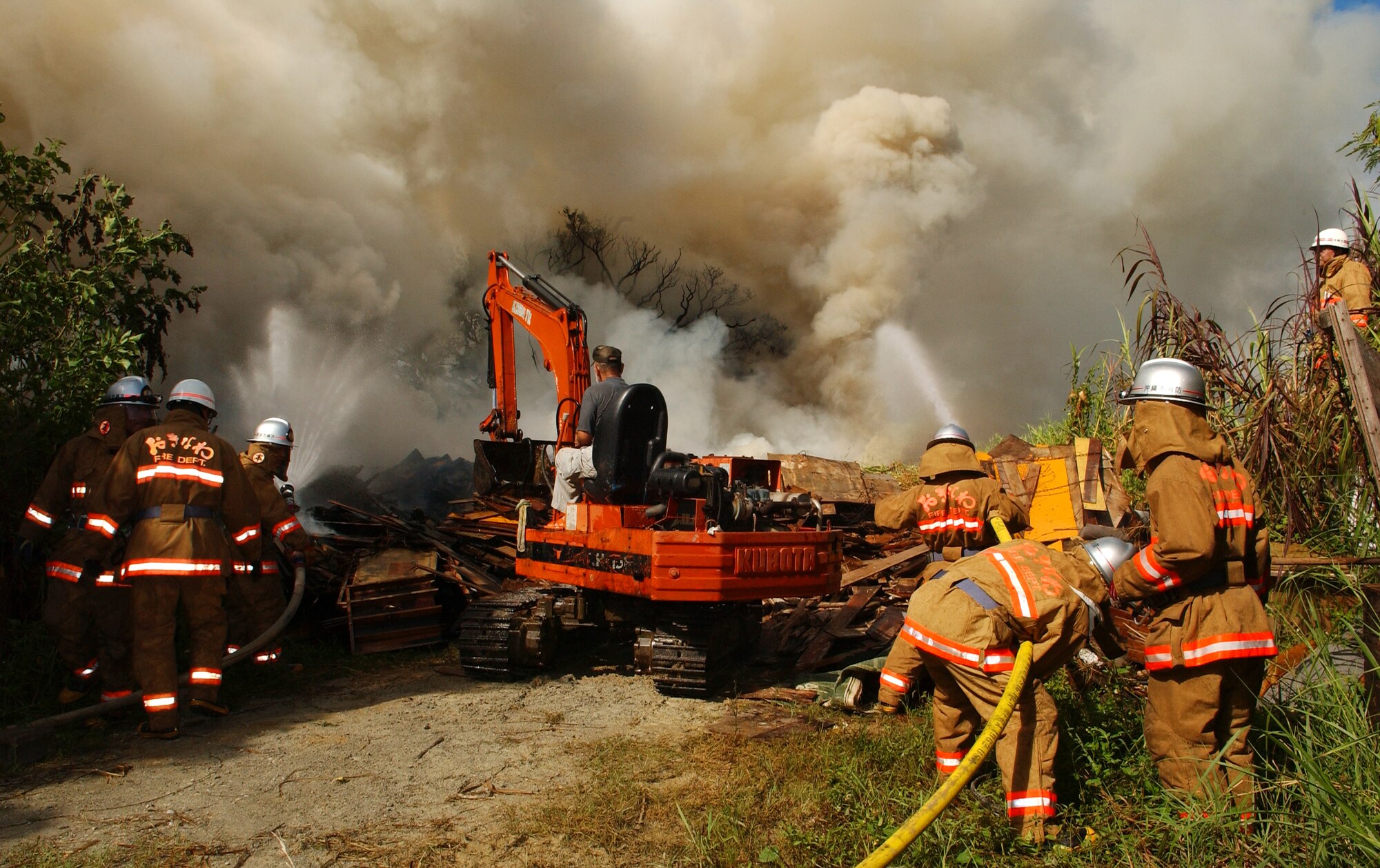 At about 7 a.m. today, Kadena Air Base, Torii Station, and Okinawa City fire departments responded to a fire in a rural area outside Gate 3. It is believed that a debris pile was the source of the fire.  The fire is contained in a 50-by-20 foot area. There were no injuries, casualties or structural damage reported. (U.S. Air Force photo / Tech. Sgt. Rey Ramon) 
